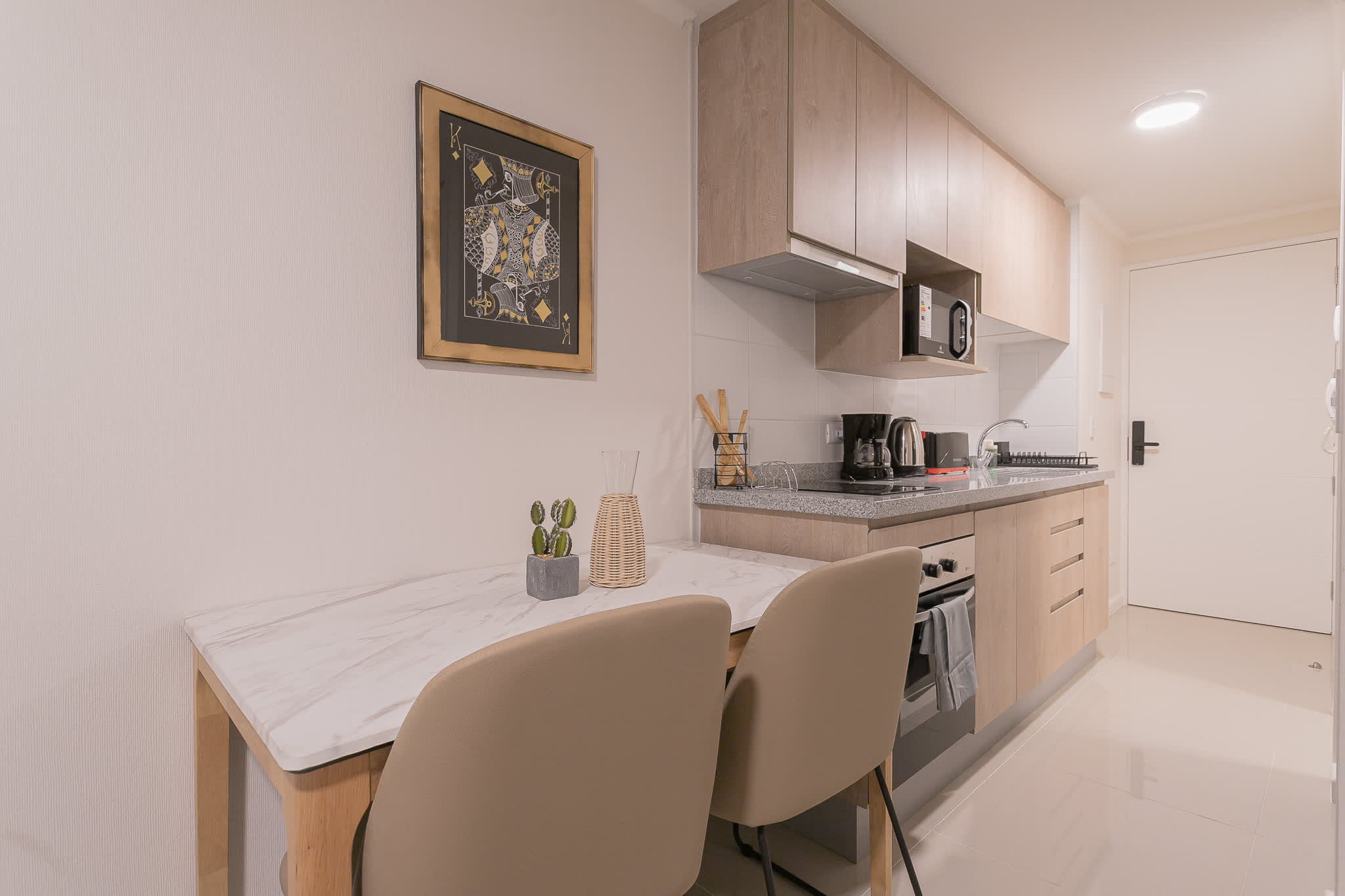 Cozy and modern kitchen with dining area, perfect for intimate meals and culinary adventures.