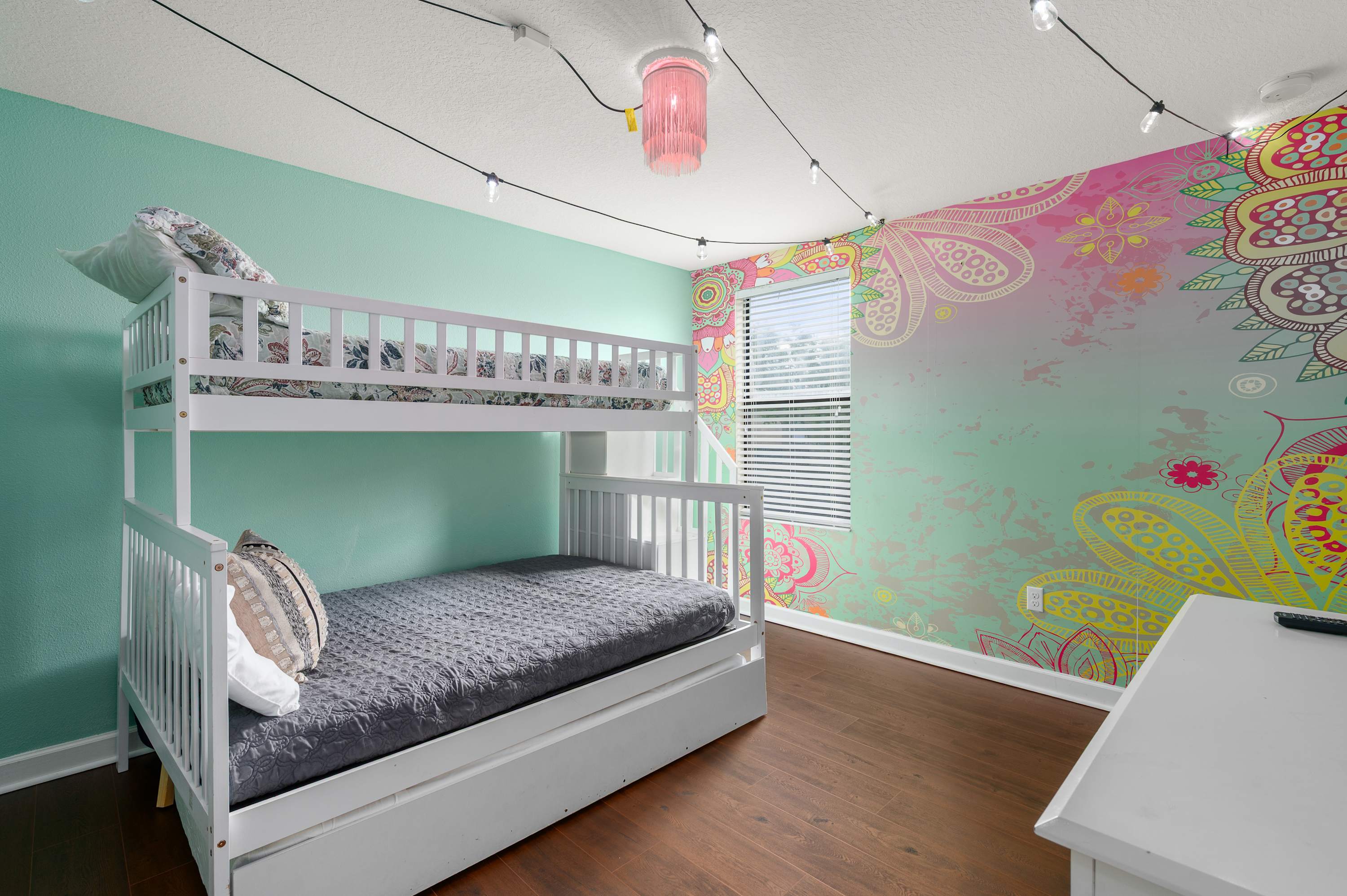 Whimsical themed bedroom w/ playful murals & cozy sleeping space for kids