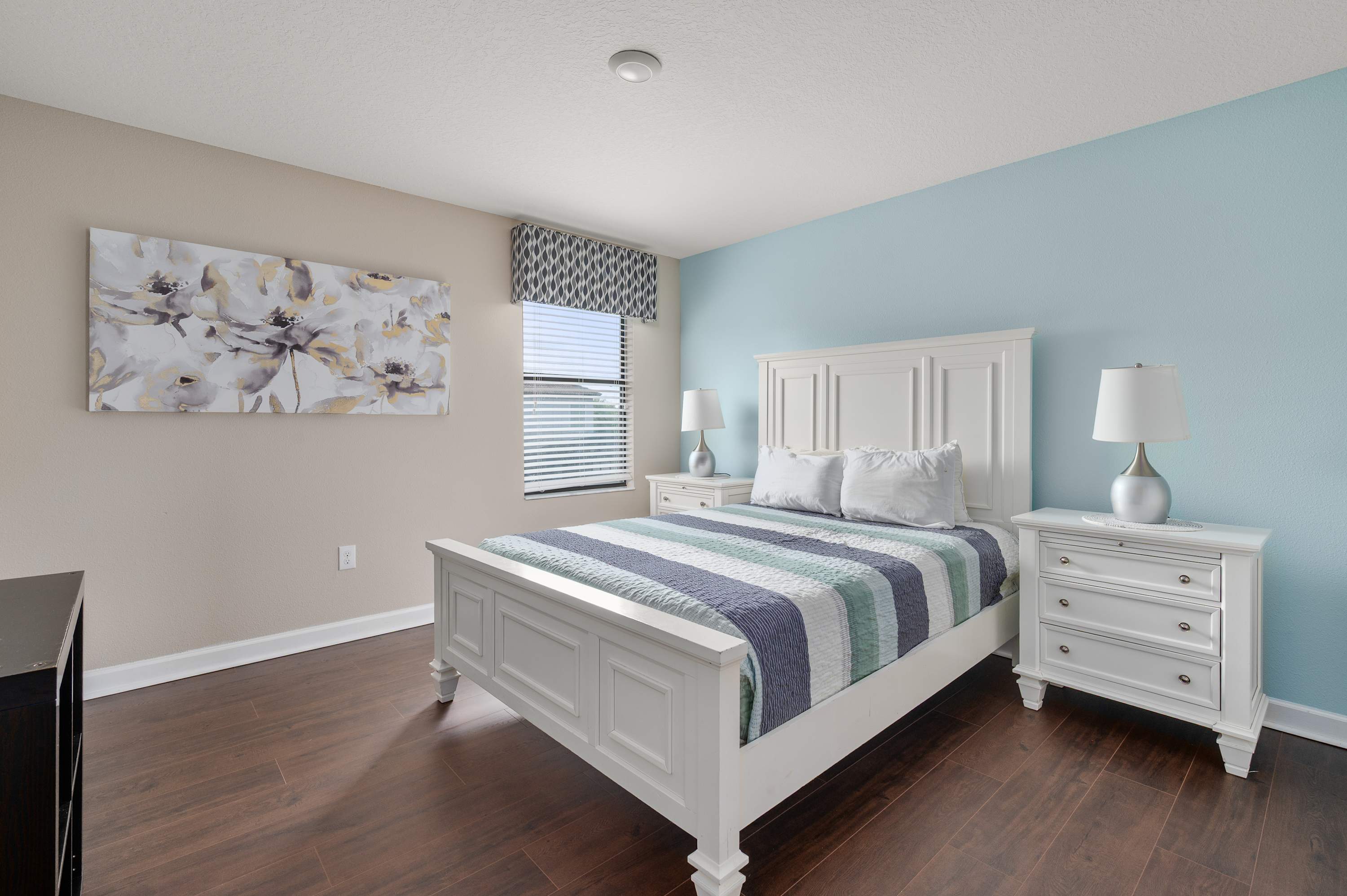 Bright bedroom w/ crisp bedding, soft tones & plenty of room to unwind