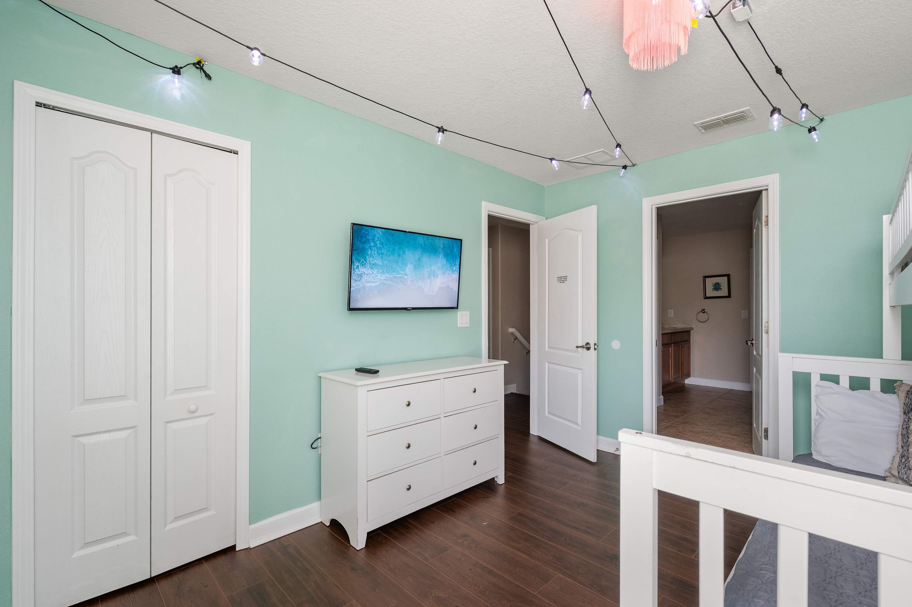 Cheerful themed bedroom w/ pastel walls, playful decor & cozy space to unwind