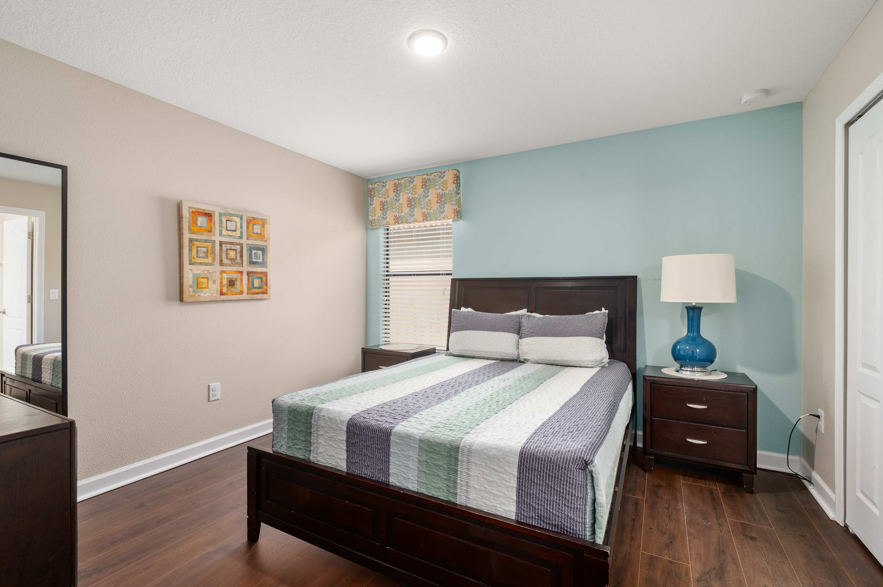 Comfortable bedroom w/ plush bedding & bedside lighting for restful nights