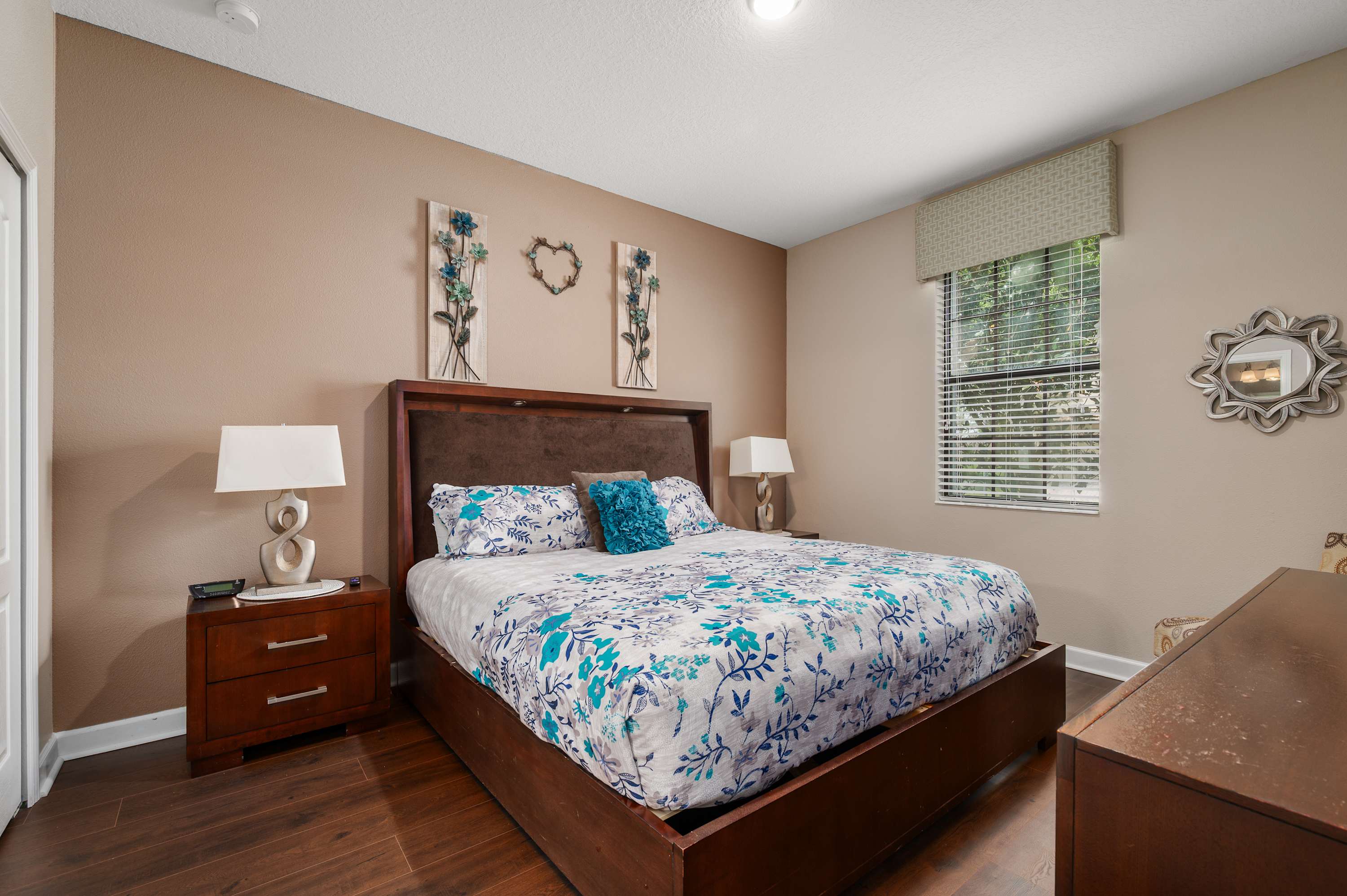 Warm bedroom retreat w/ wood furnishings & colorful bedding accents