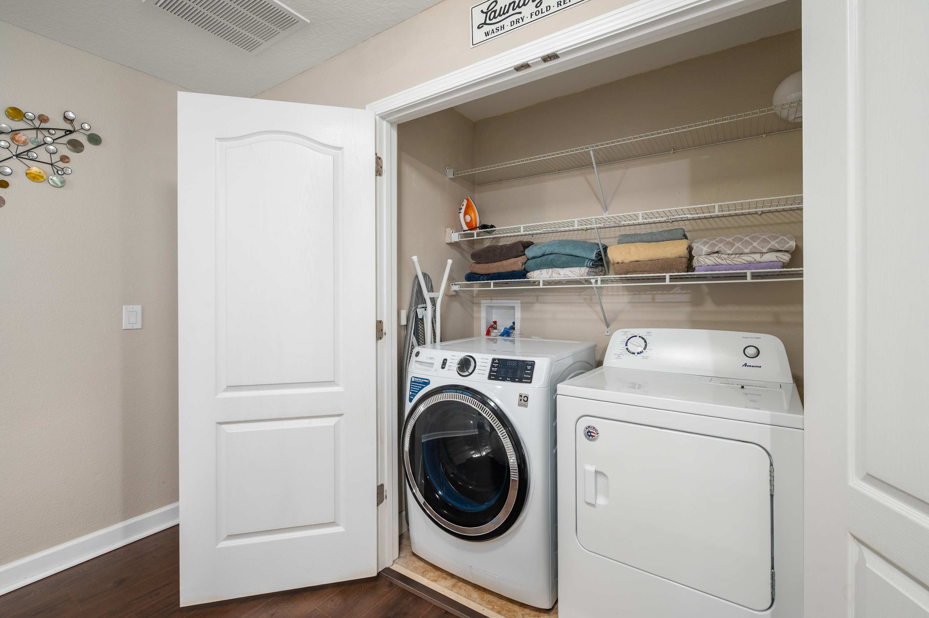 Convenient laundry area w/ washer, dryer & shelving for longer stays