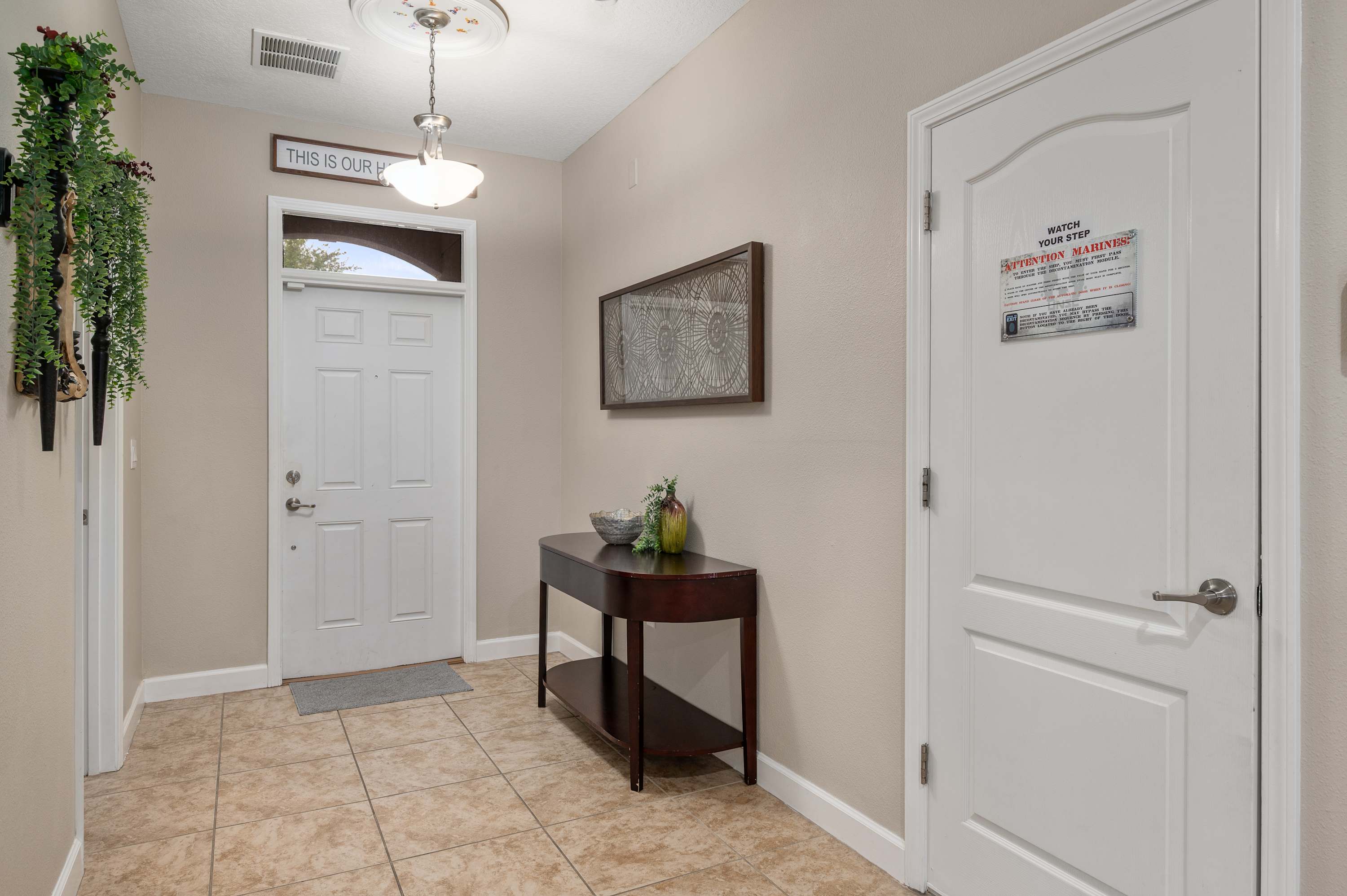 Bright entryway leading into the living space w/ welcoming decor touches