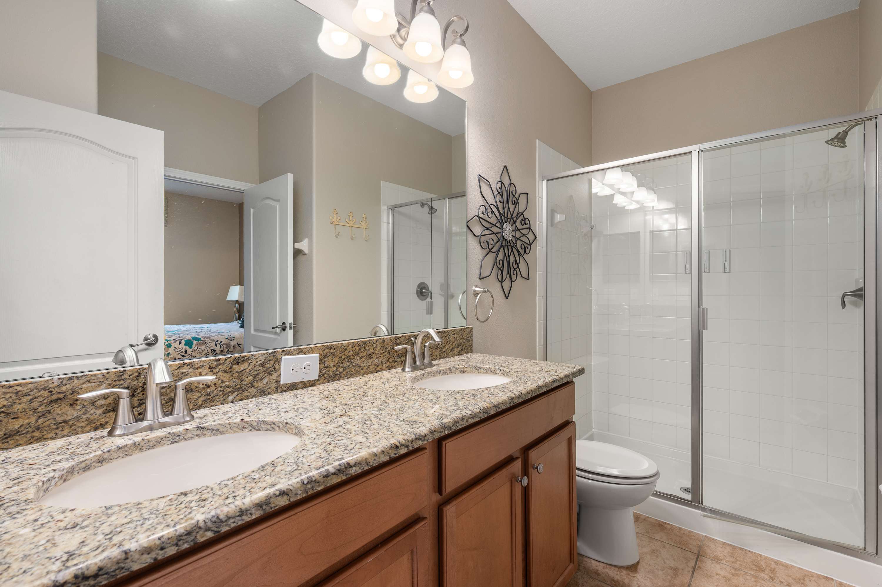 Bright bathroom w/ glass shower, granite vanity & fresh clean finishes