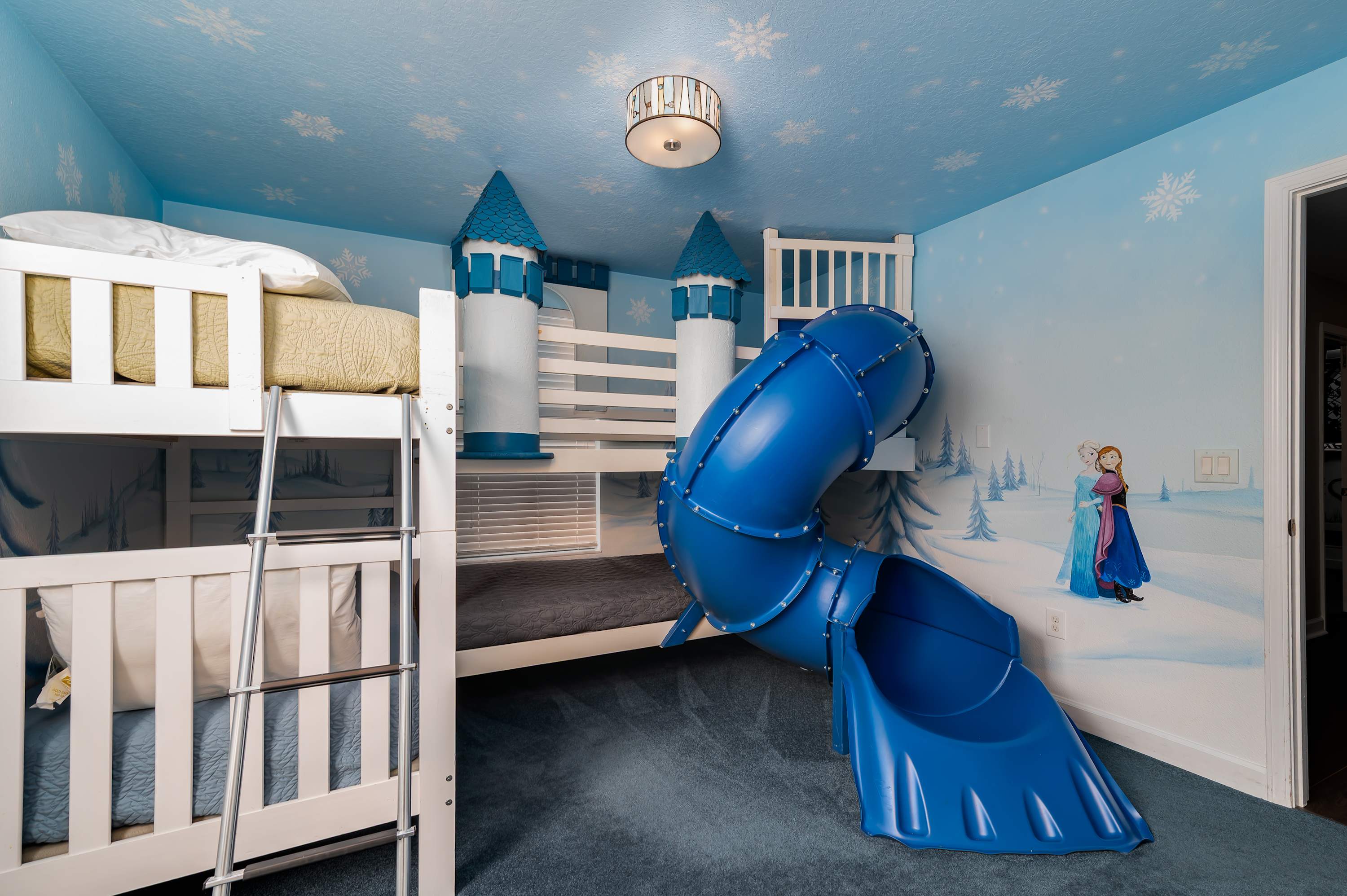 Colorful kids’ room w/ bunk beds & slide made for fun-filled sleepovers