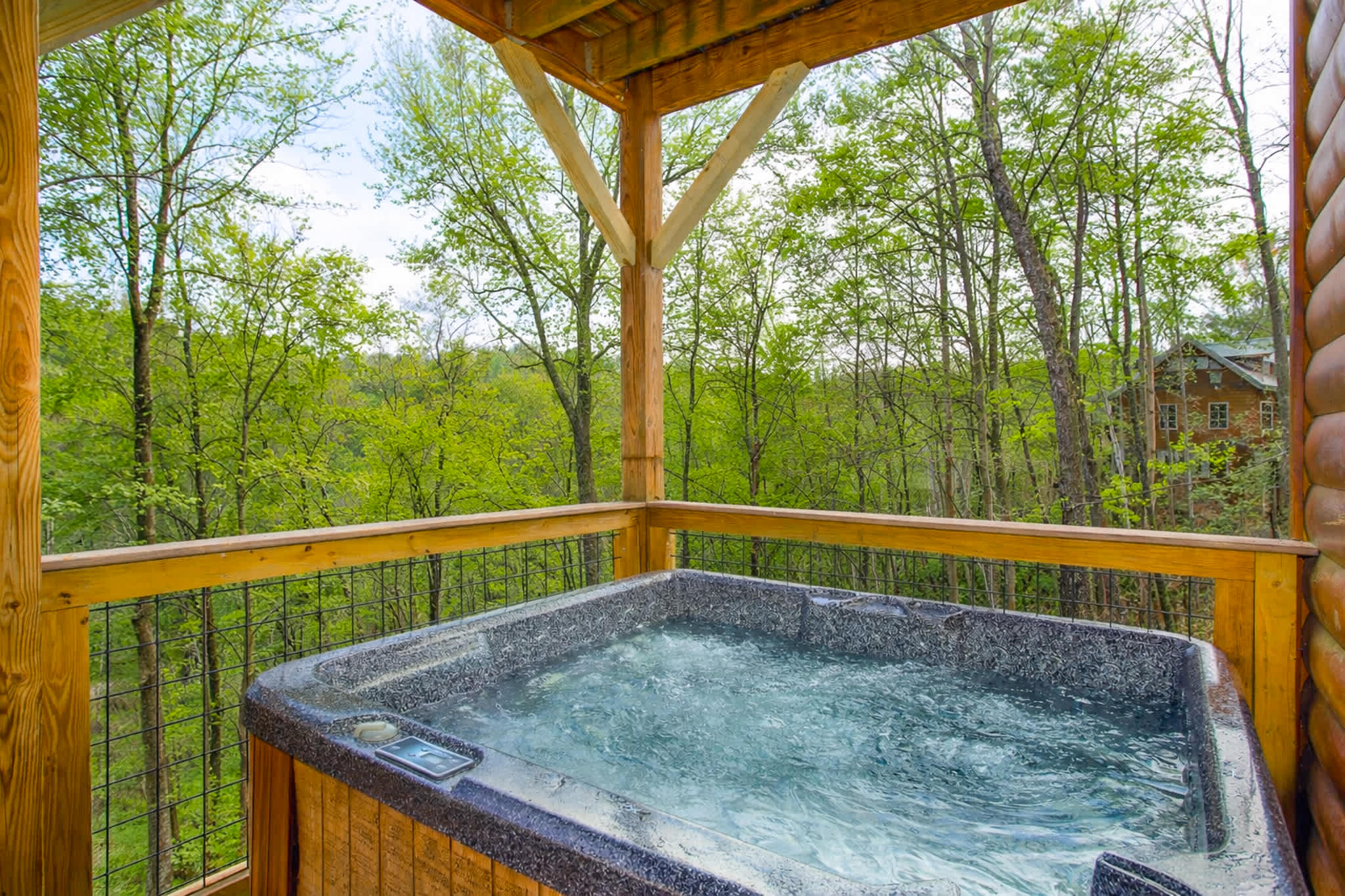Relax in the hot tub with wooded views.