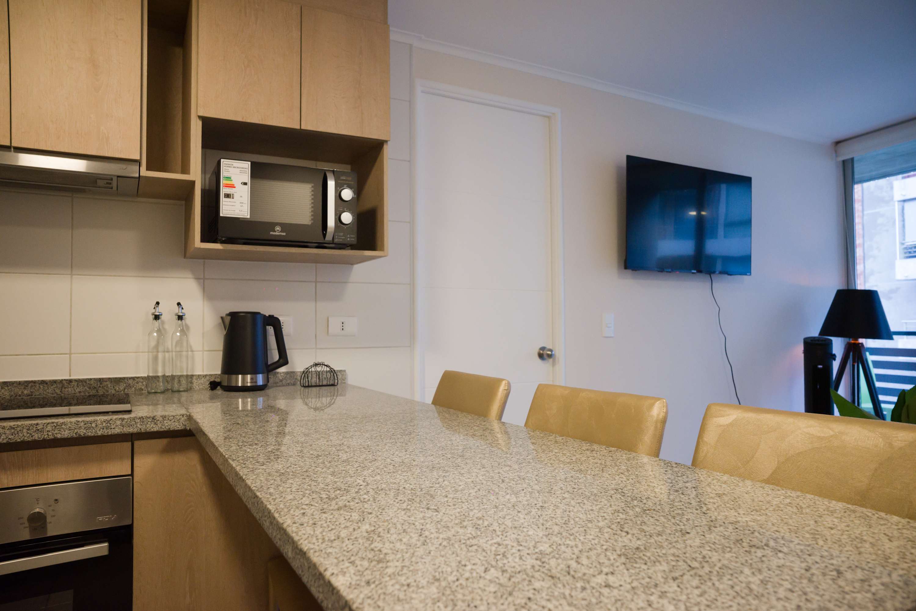 Modern kitchen with granite countertops and convenient amenities, perfect for a cozy stay.