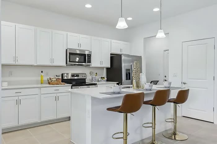 Sleek modern kitchen with stainless steel appliances and a spacious island for casual dining and entertaining.