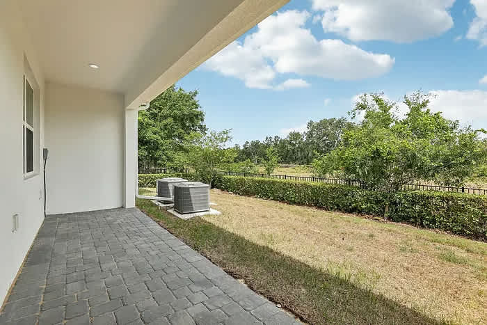 Relax on your private patio with serene views of lush greenery and open skies.