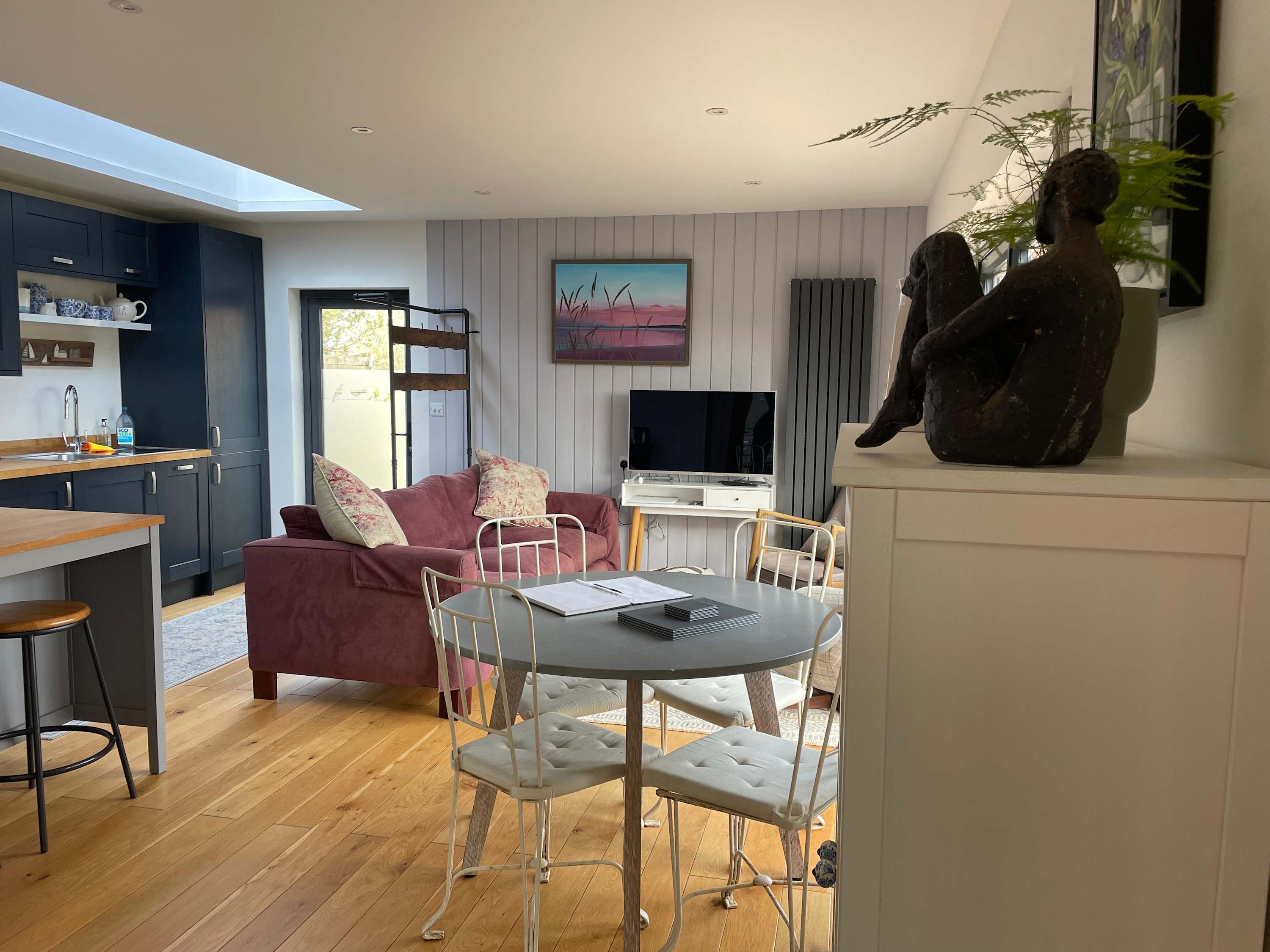 The open plan kitchen, living and dining space is homely and cosy, with different areas to sit and relax.