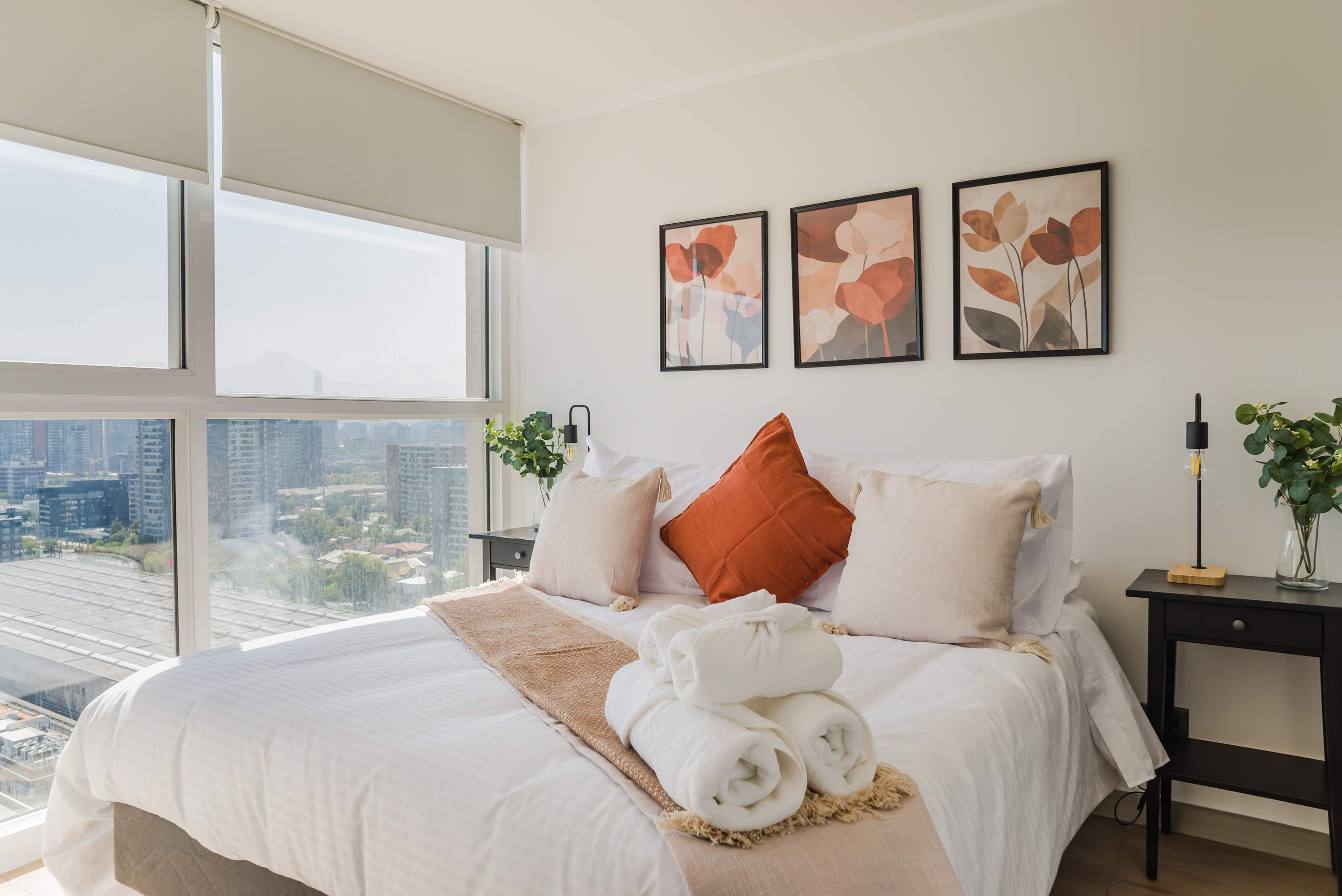 Relax in this bright and stylish bedroom with stunning city views and modern decor, perfect for a tranquil stay.