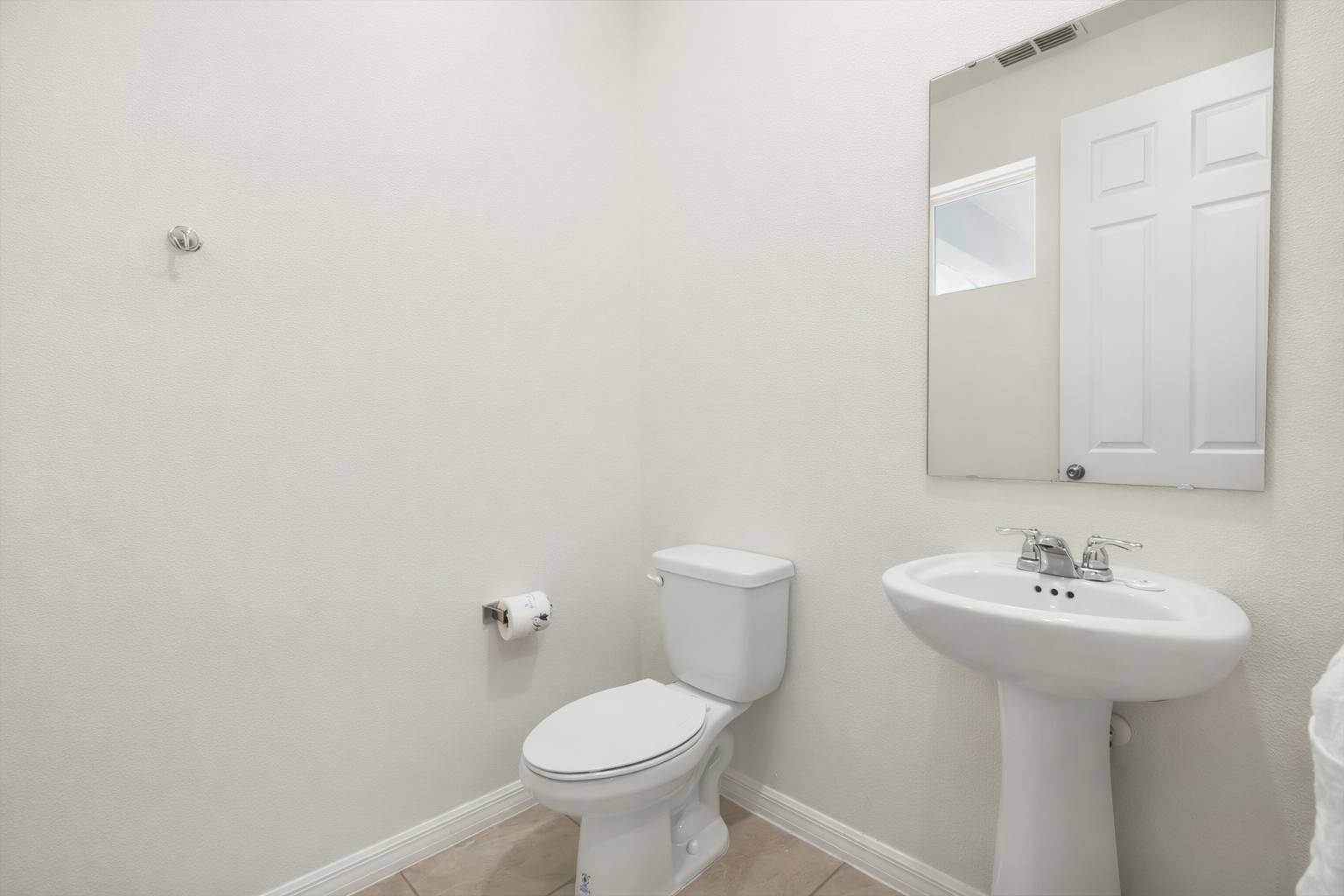 Convenient half bathroom with toilet and sink