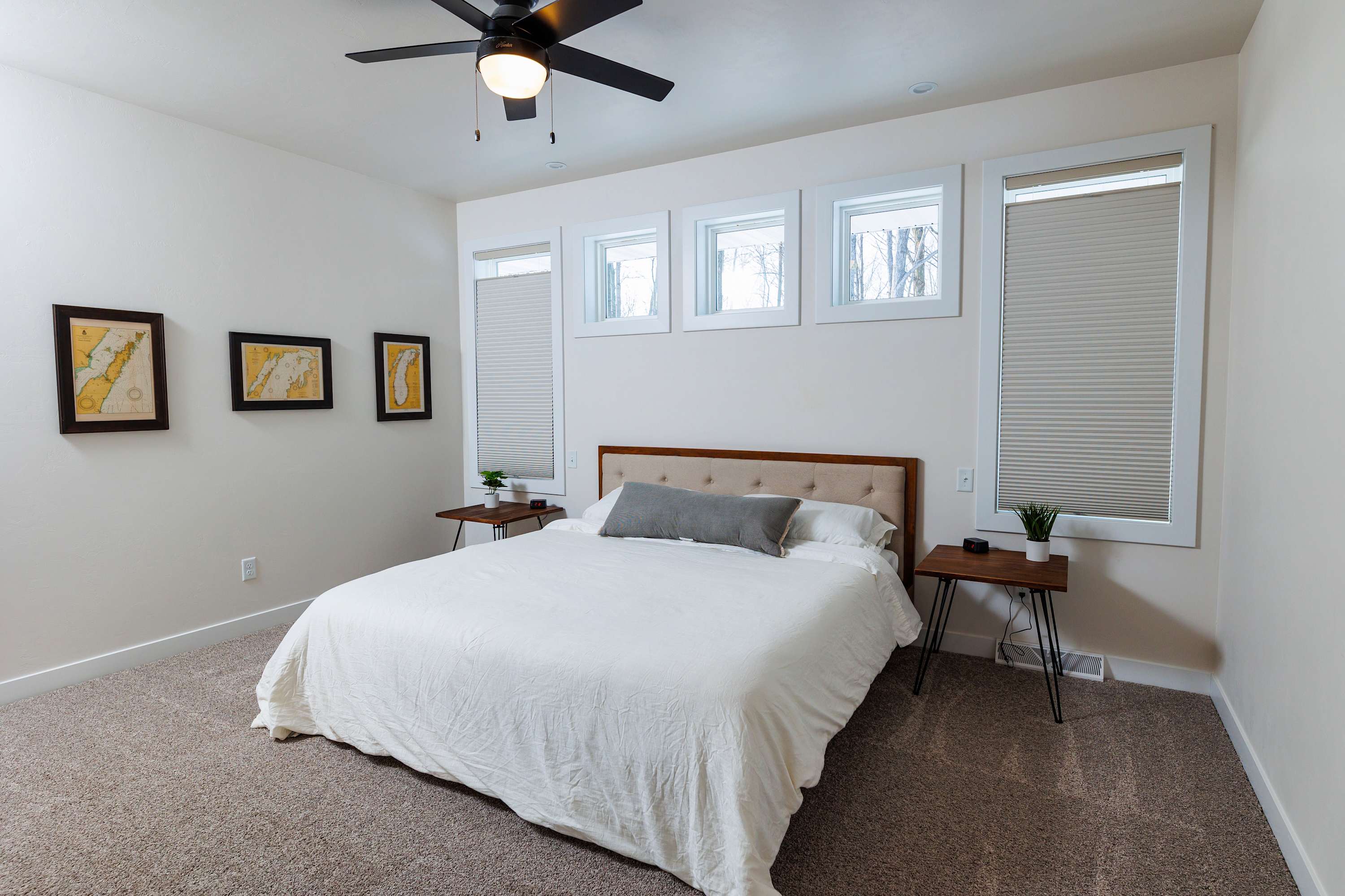 King size bed and ceiling fan in main bedroom on the main level