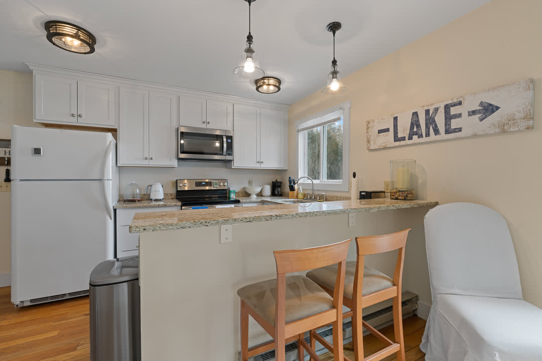 Fully stocked kitchen includes counter seating for 2