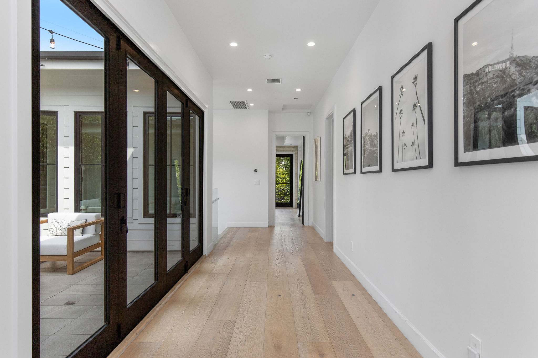 A gallery-style hallway that connects the home with clarity, light, and architectural flow