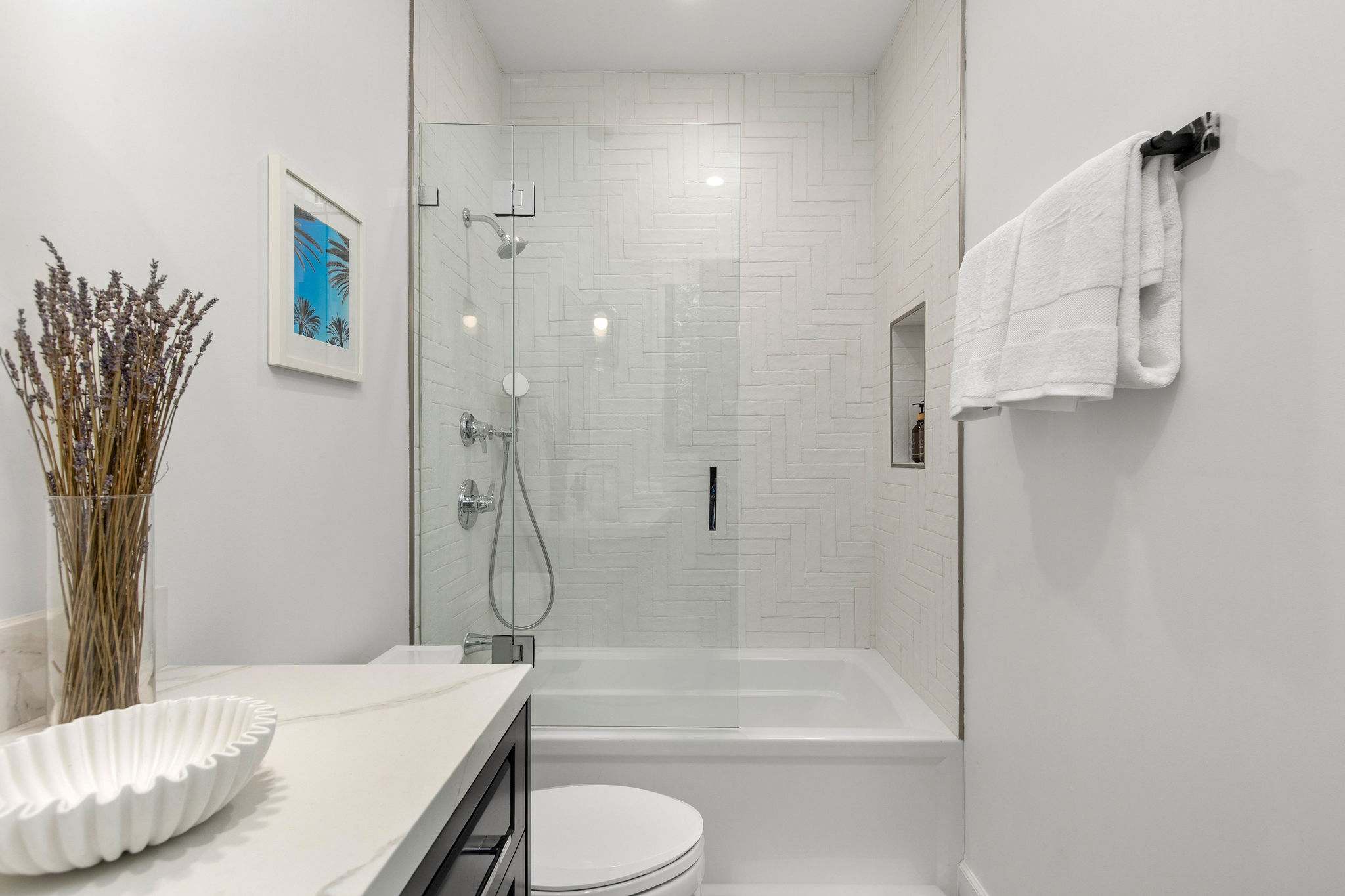 A full bathroom with tub and shower combination, finished in a clean modern farmhouse palette
