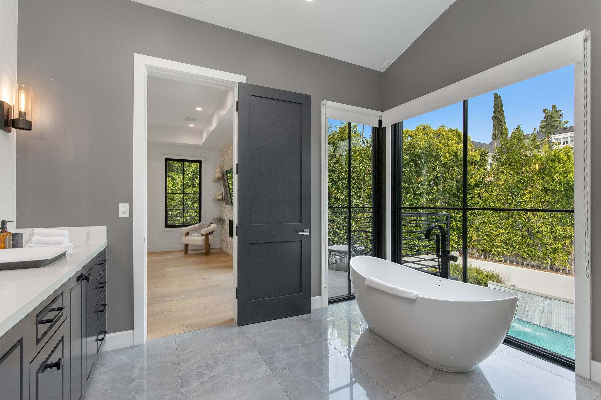 A primary bathroom designed as a spa-style retreat with freestanding tub, walk-in shower, and premium fixtures