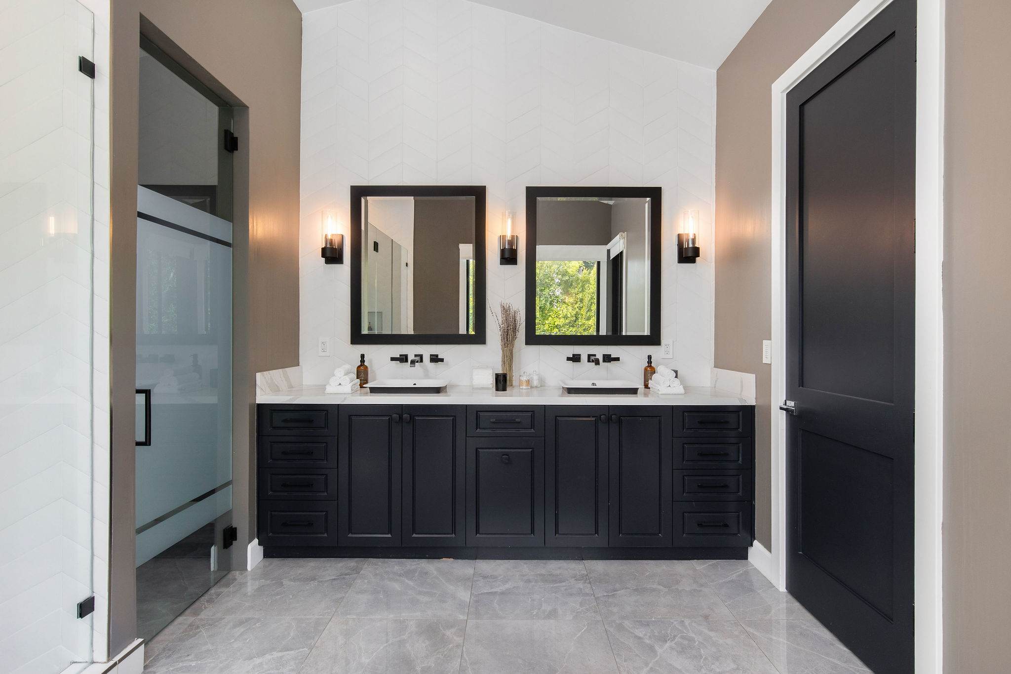 Double vanity layouts with stone surfaces and custom cabinetry