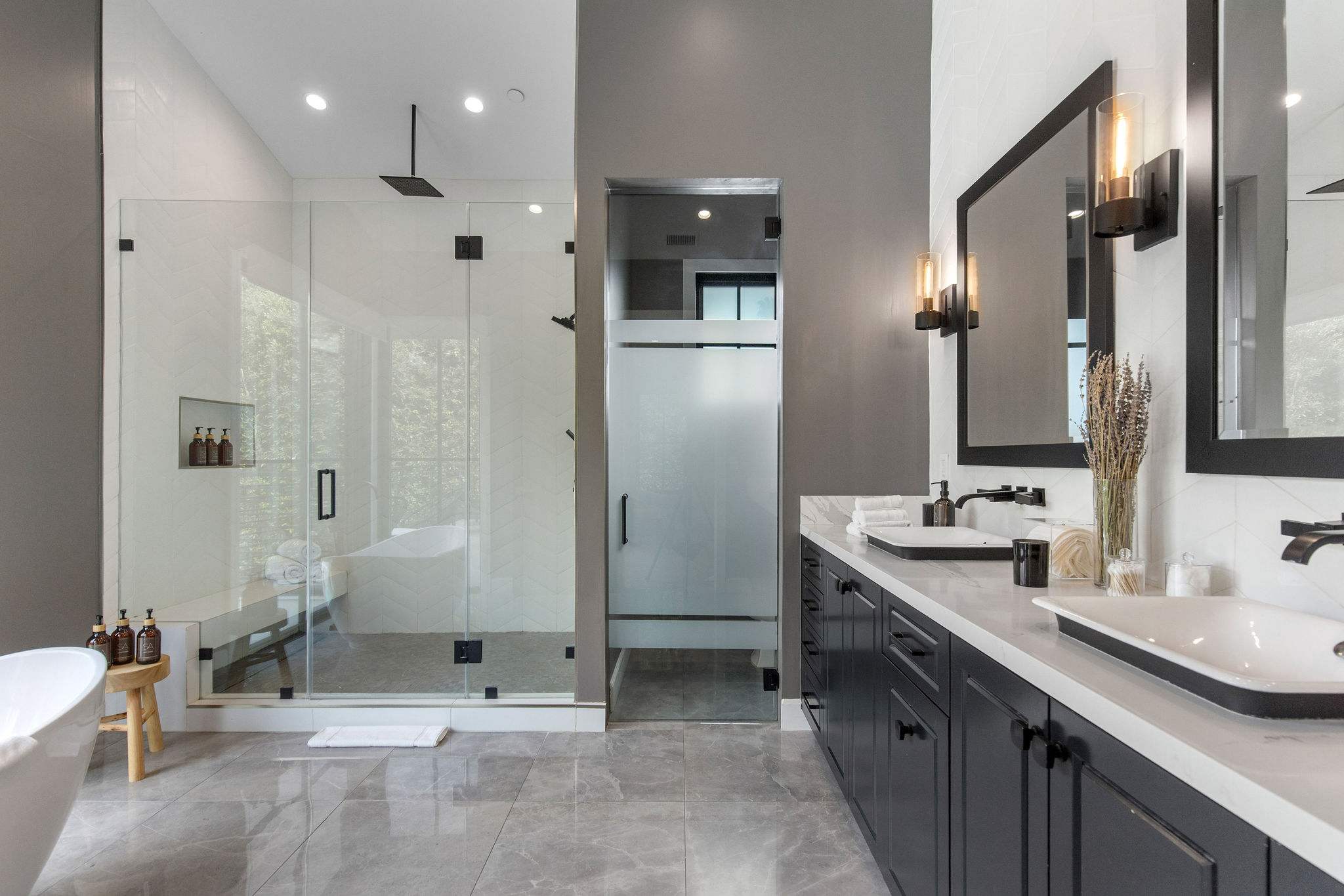 A full bathroom with tub and shower combination, fully equipped with premium toiletries.