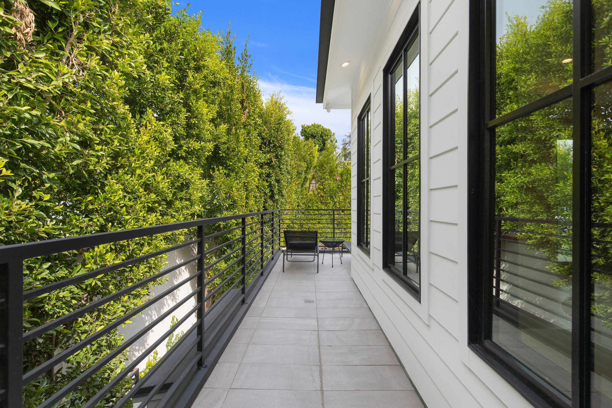 An upper-level terrace designed for private outdoor living with direct access from the bedrooms