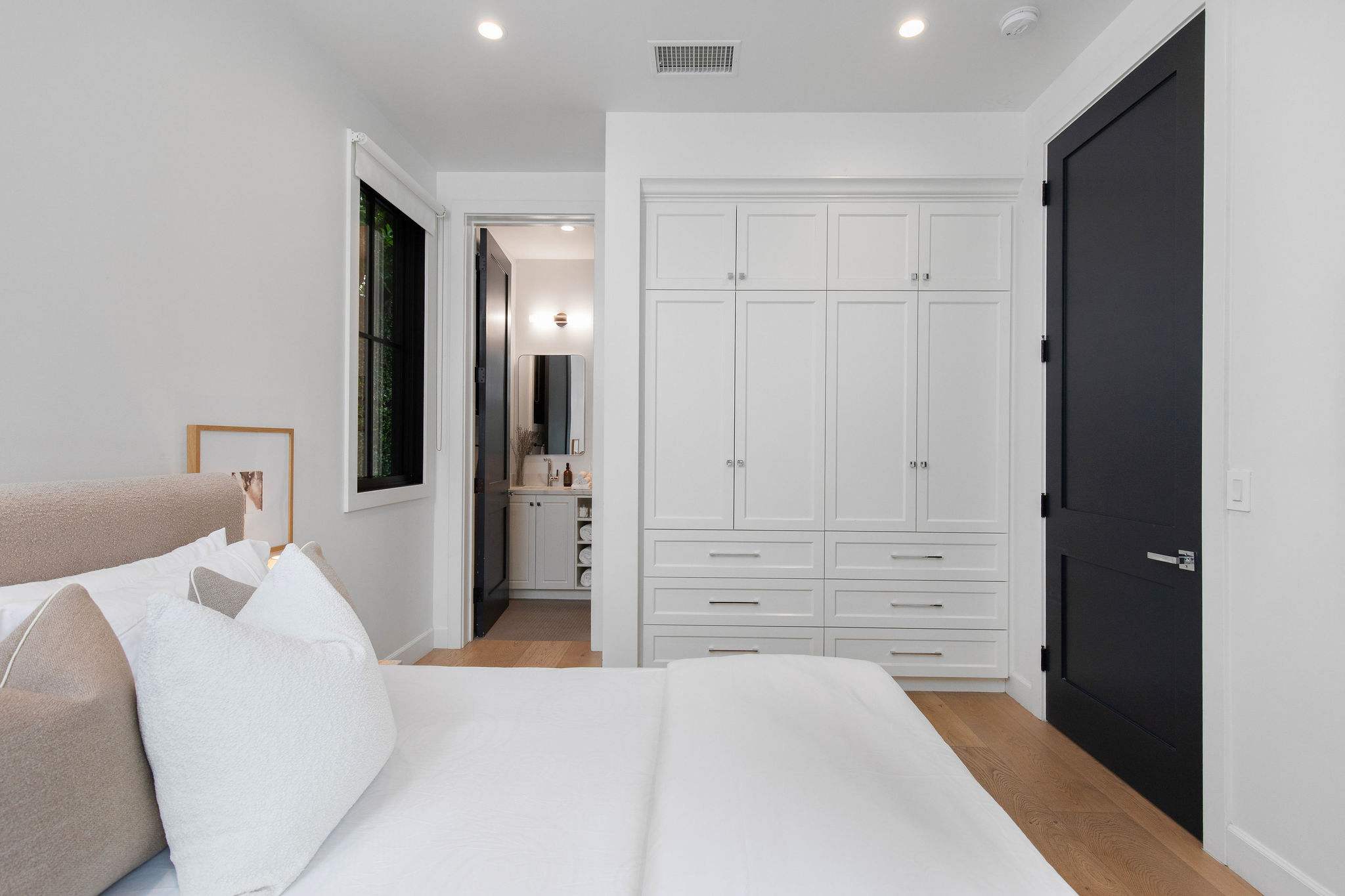 A private guest bedroom in West Hollywood with built-in storage and a clean, refined design palette