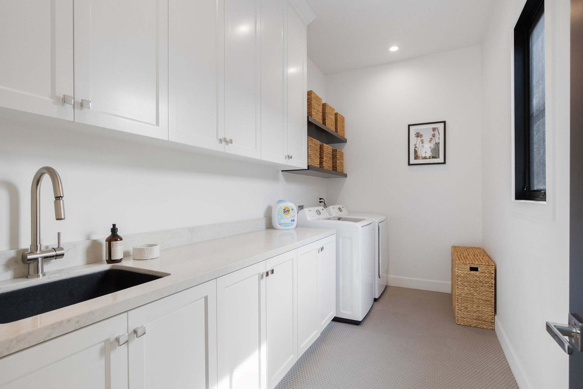 A dedicated laundry room with full-size washer and dryer, built-in cabinetry, and space designed for extended stays