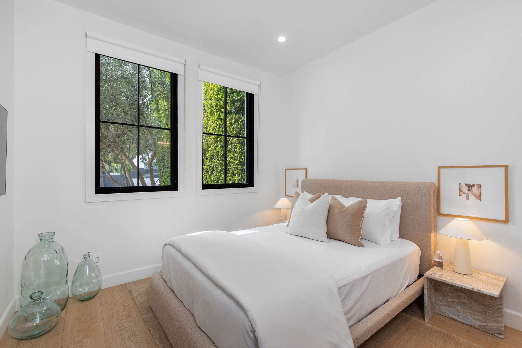A guest bedroom with a calm, refined design and consistent modern farmhouse detailing