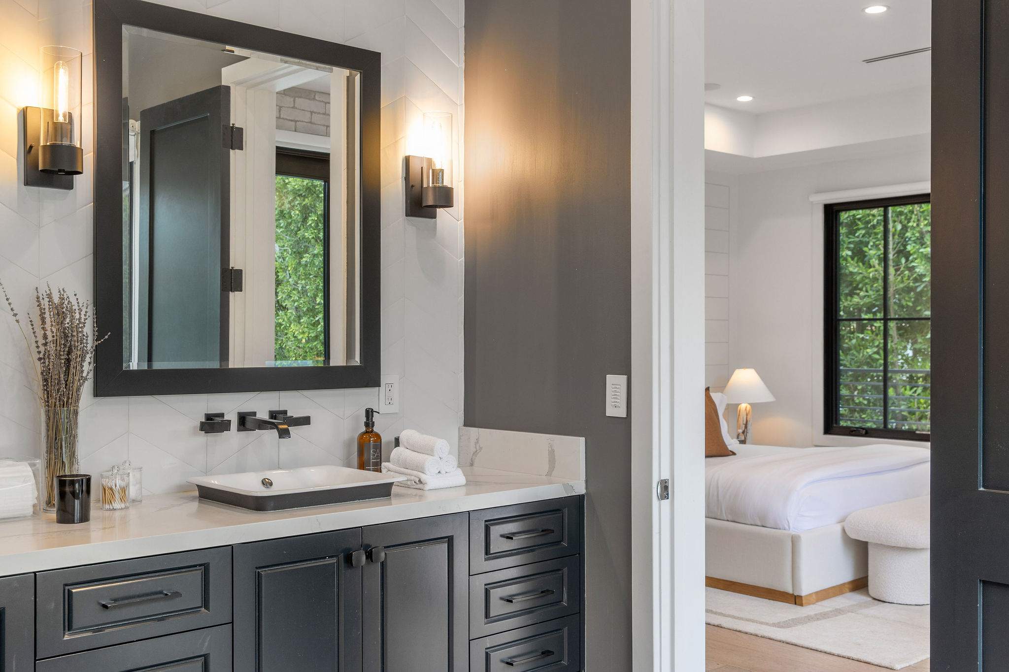 A bathroom with double vanity, custom cabinetry, and clean modern finishes
