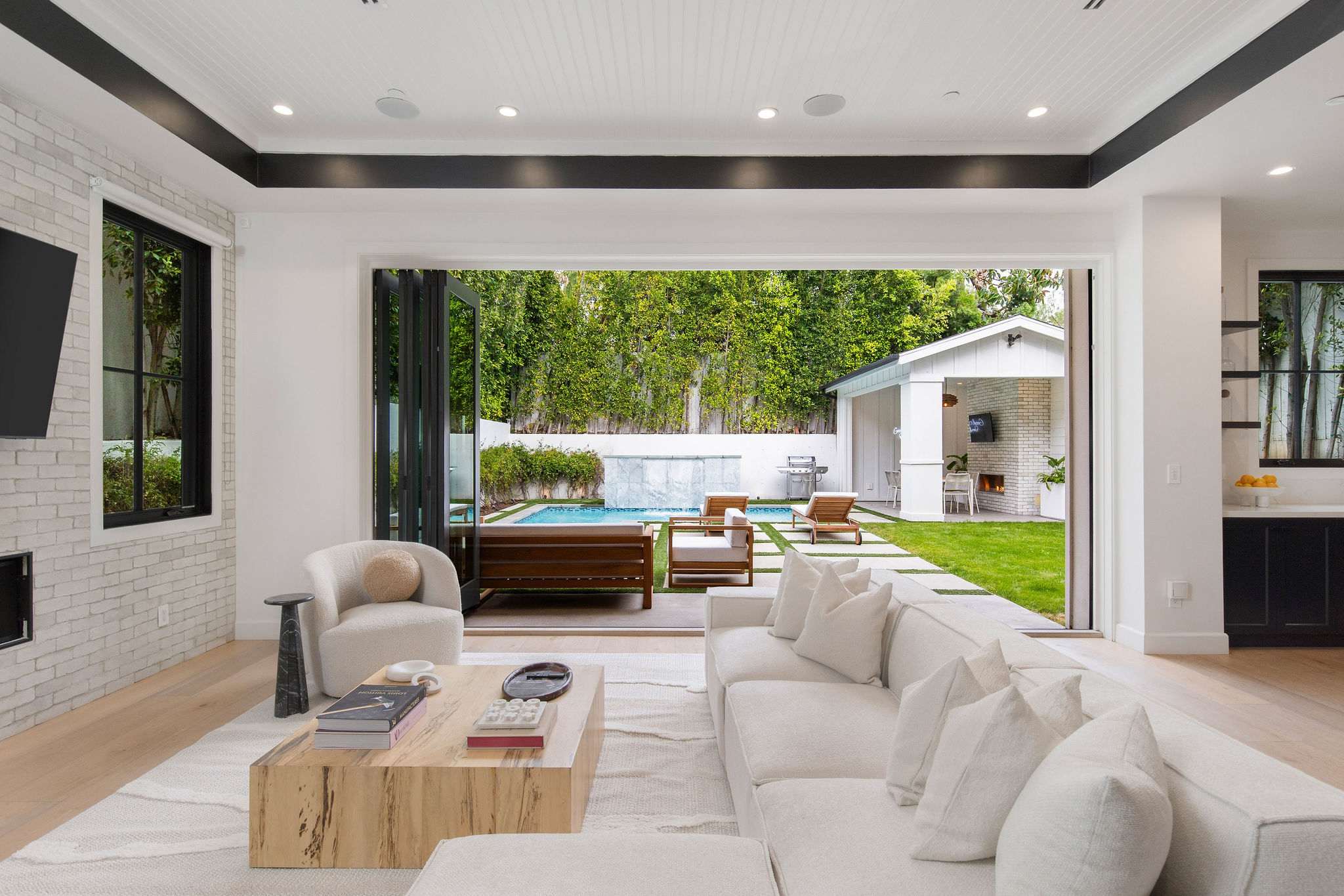 Open the sliding doors and extend your living space directly to the pool and outdoor lounge