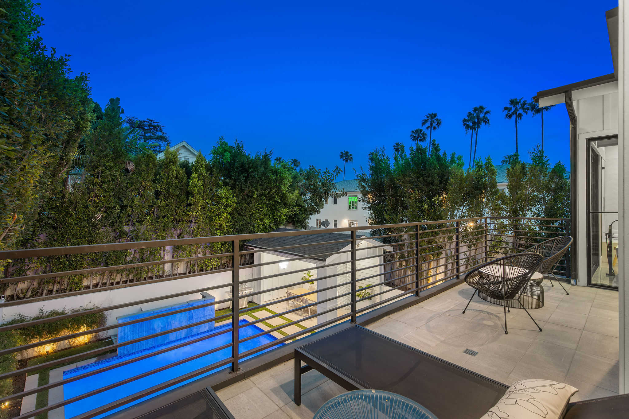 An upper terrace in West Hollywood with pool views, offering a more elevated outdoor living perspective