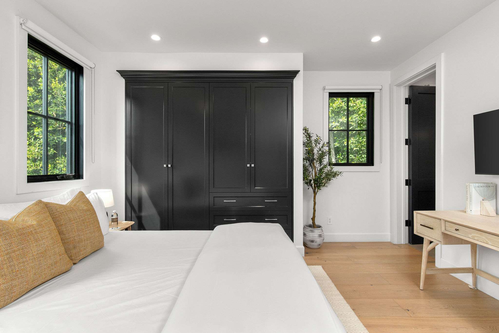 A private guest bedroom with built-in storage and a clean, modern farmhouse finish