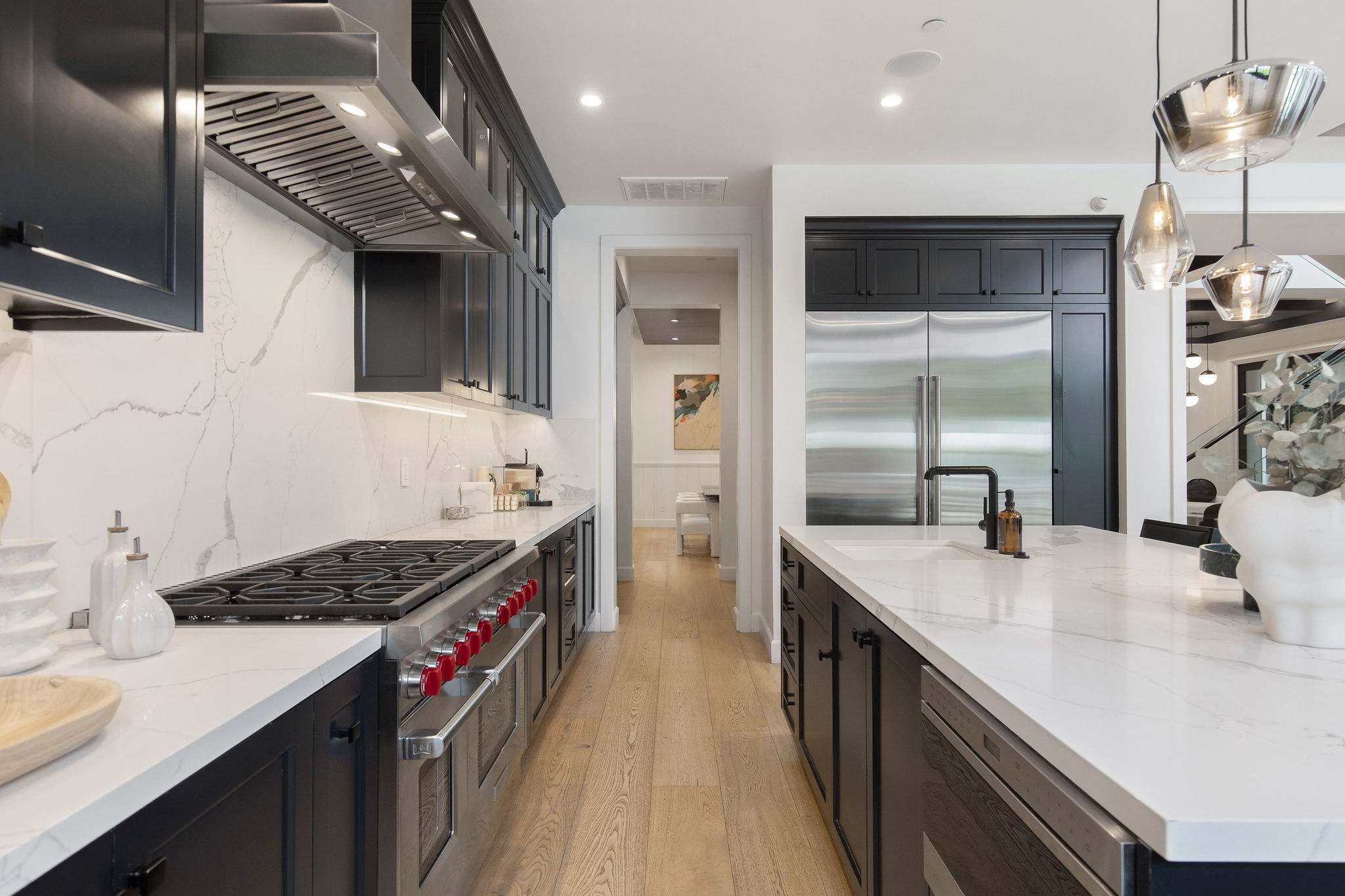 A chef’s kitchen with oversized island, premium appliances, and modern farmhouse design