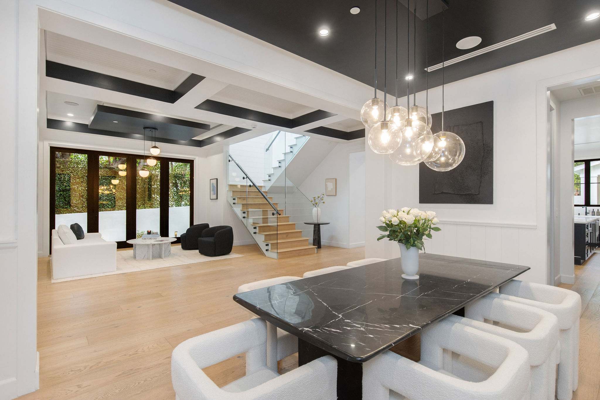 A formal dining space in West Hollywood with statement lighting and open-plan connection