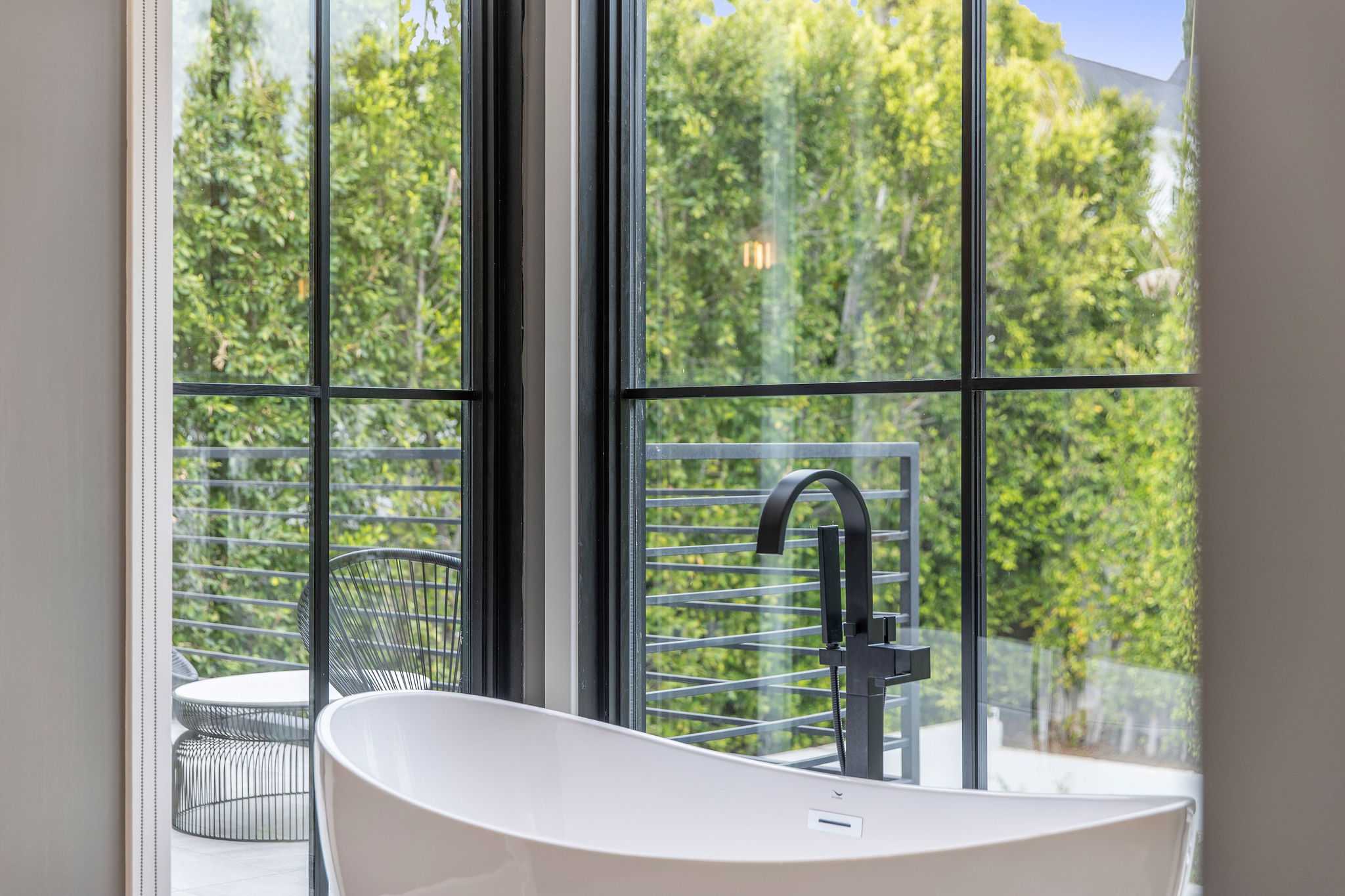 Spa-style primary bath with freestanding soaking tub