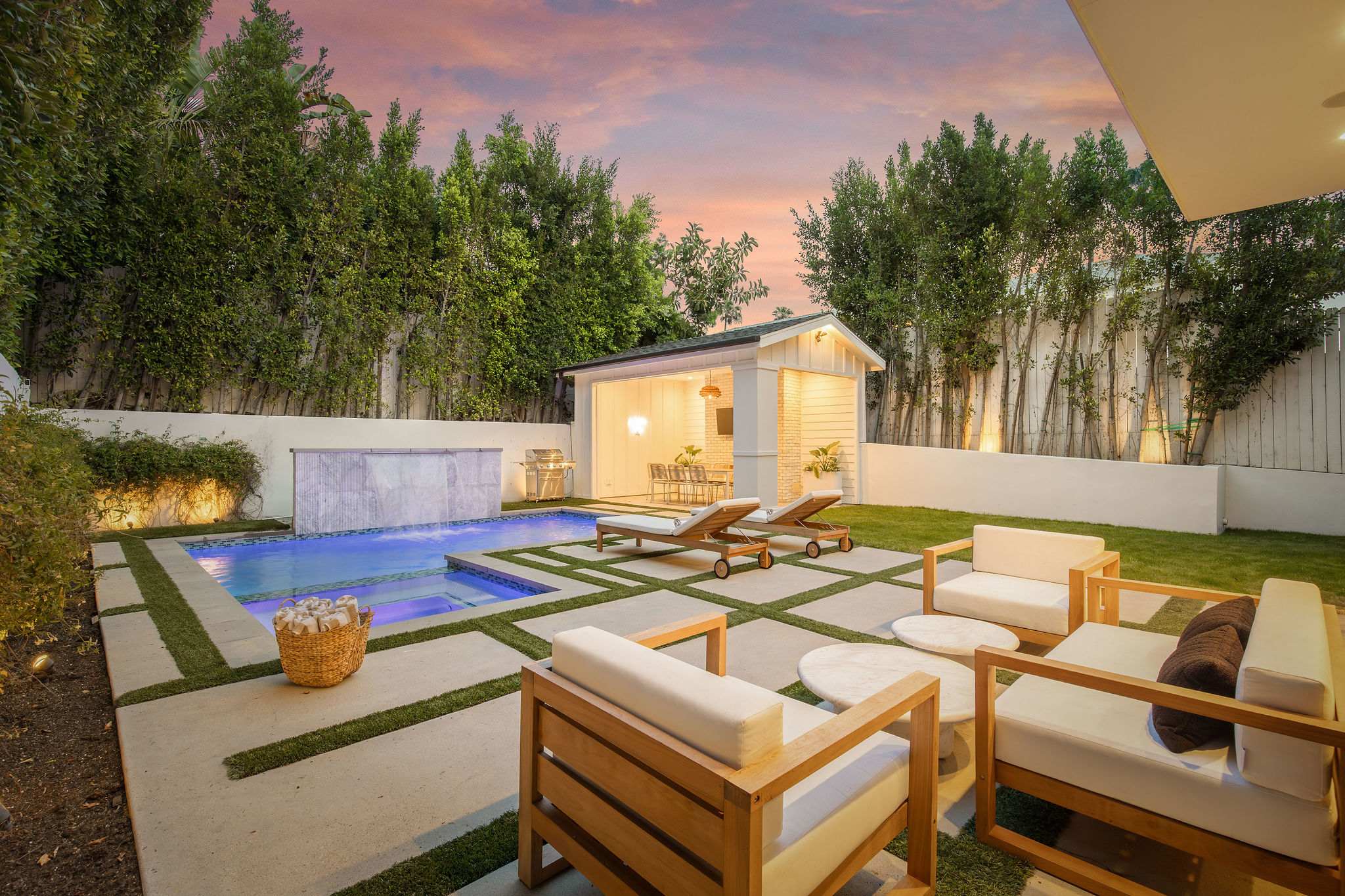 A layered outdoor living experience in West Hollywood with multiple lounge zones, dining areas, and landscaped design