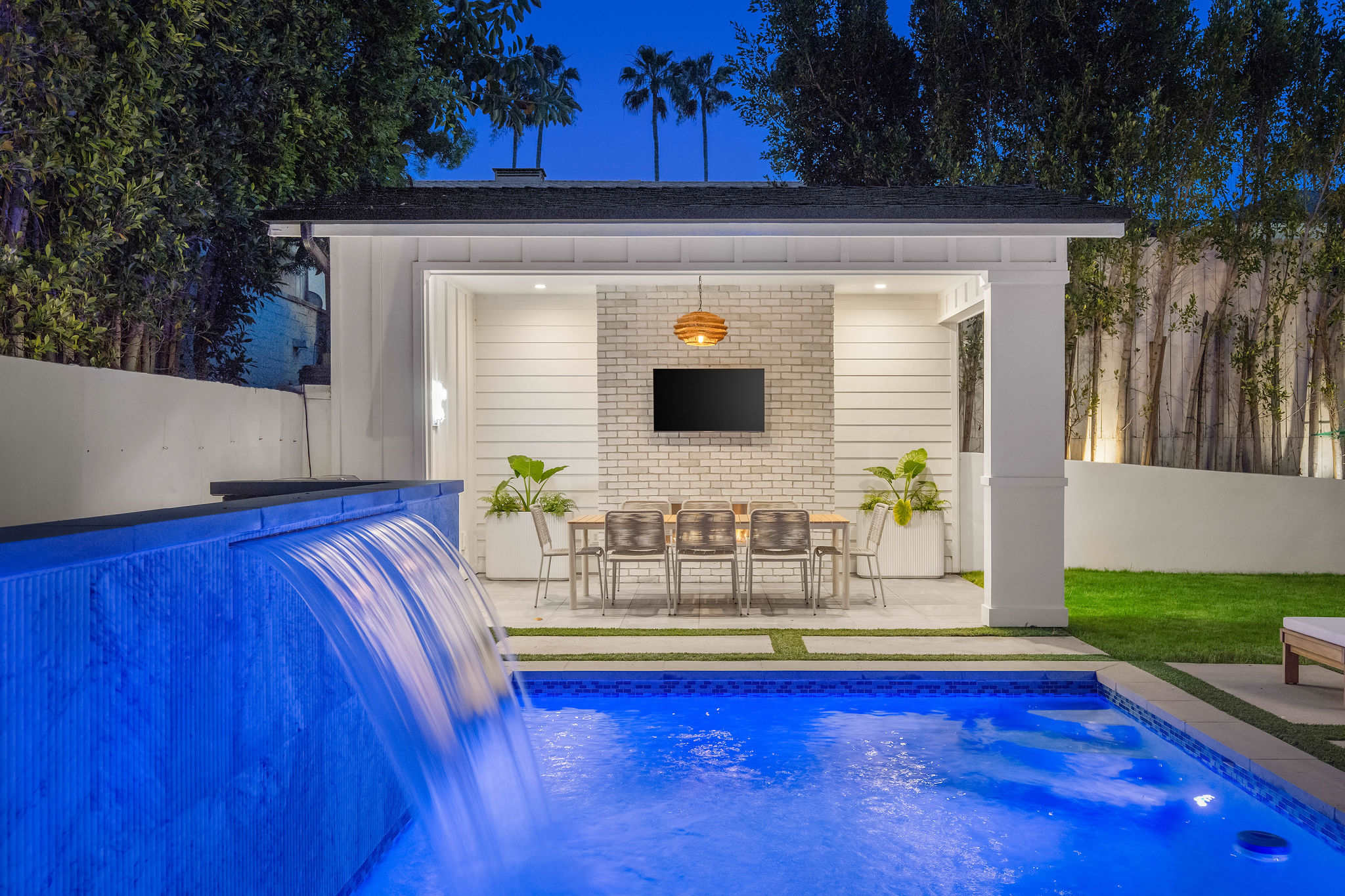 The cabana becomes your go-to for late nights, with fireplace lounge and waterfall pool feature