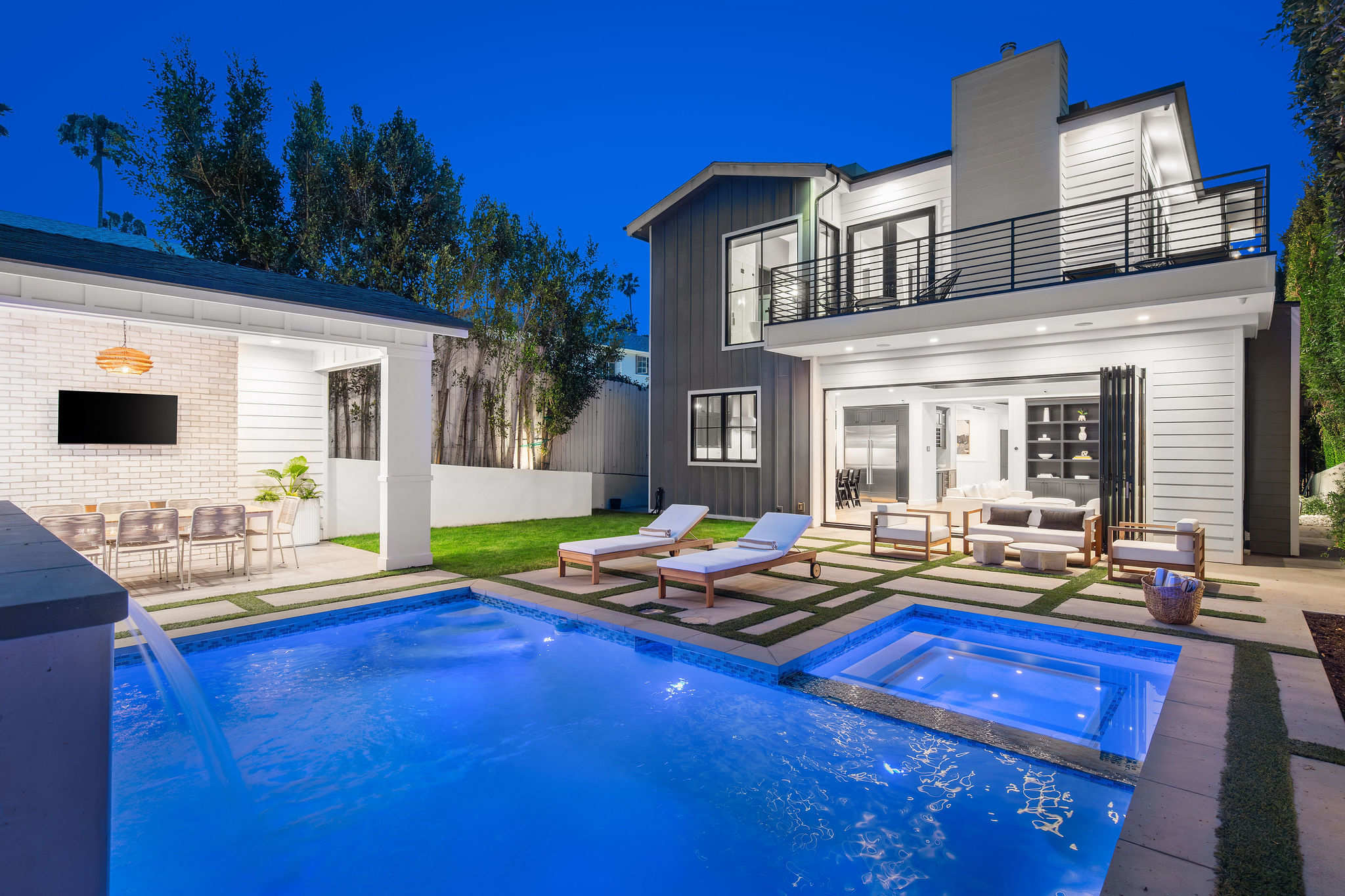 A resort-style pool and spa in West Hollywood with cabana, fireplace, and full outdoor entertaining setup