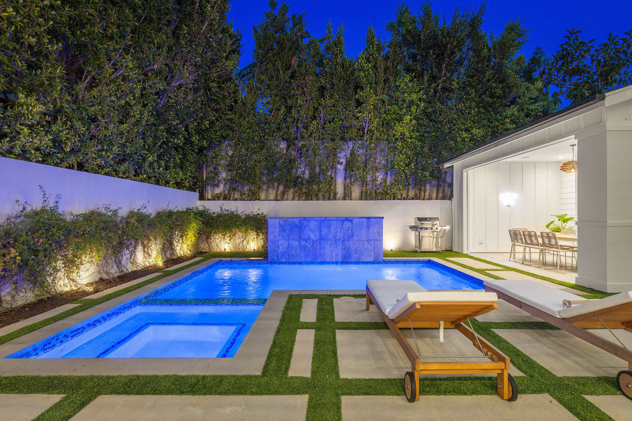 A fully enclosed West Hollywood backyard with pool, spa, and lounge areas designed for privacy and evening use