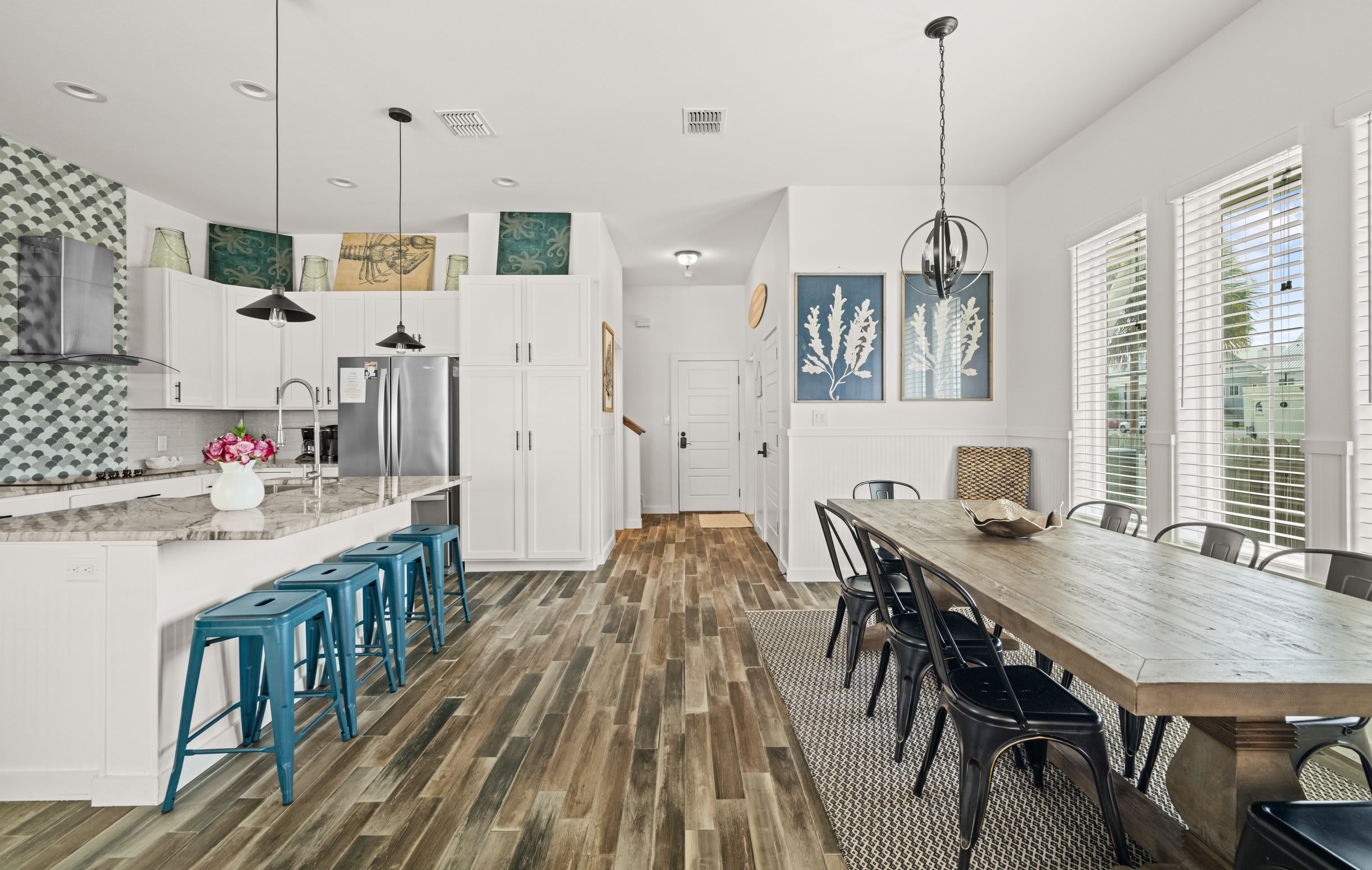 Kitchen & Dining — White Island, Teal Stools, Scallop Backsplash, Rustic Wood Table & Coral Art