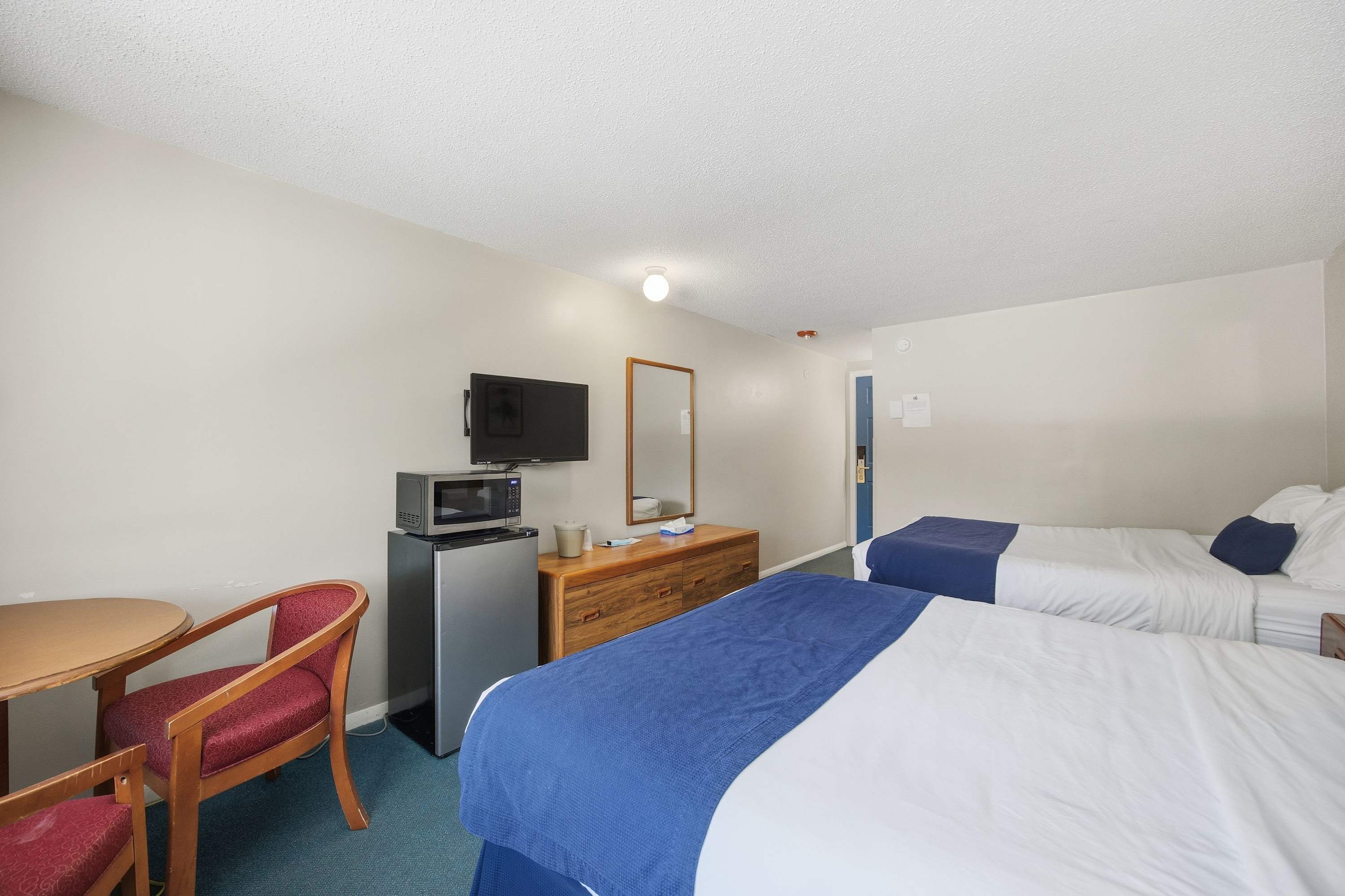 Recharge with a pair of plush queen beds in this studio-style home​