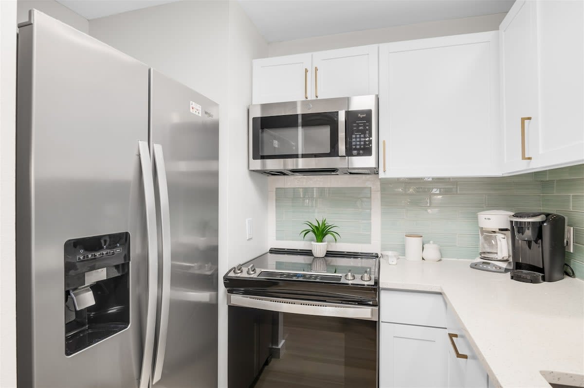 Kitchen: Keurig, drip coffee maker, blender, toaster, cooking utensils, tableware