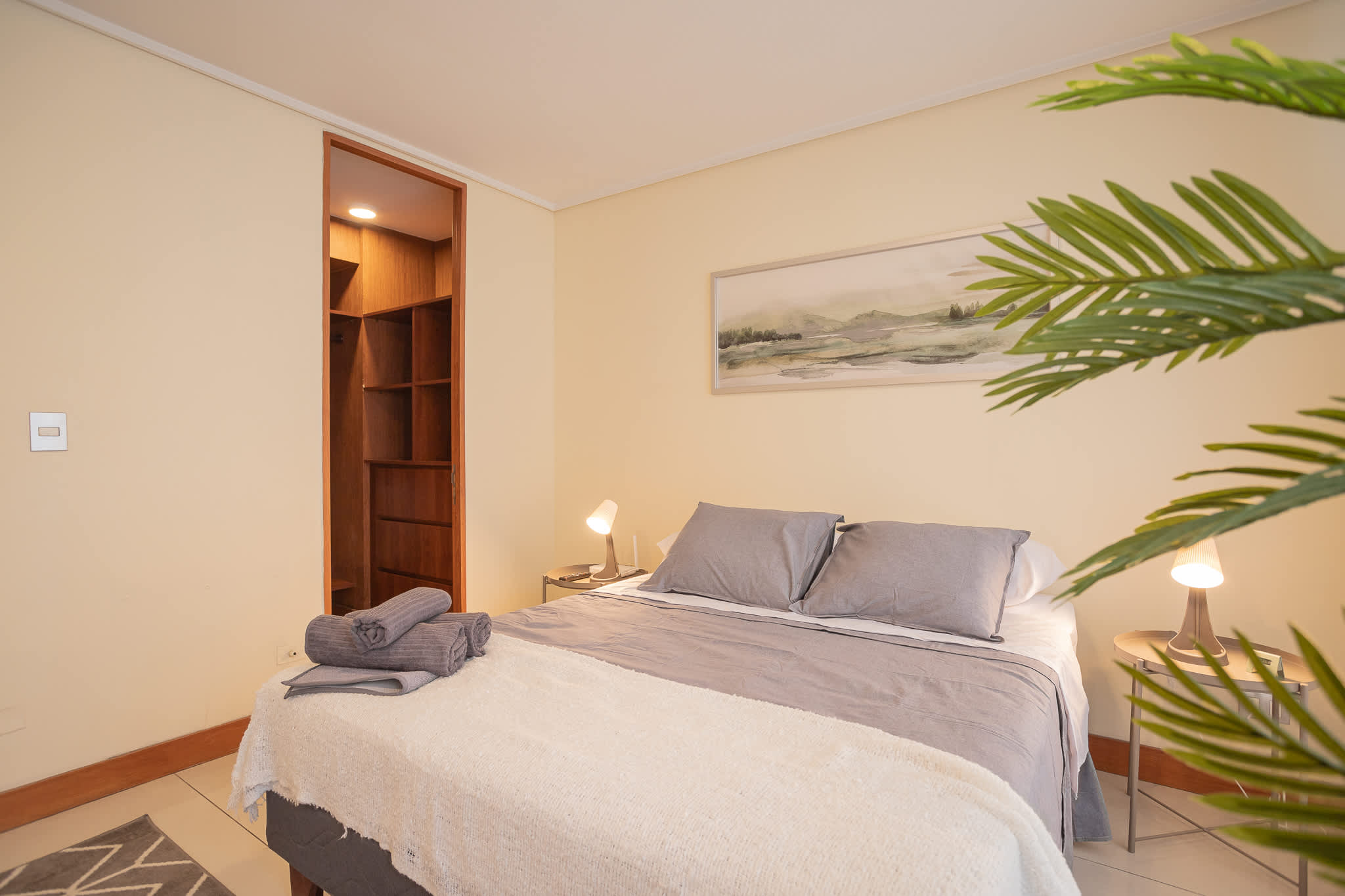Relax in this cozy studio bedroom with soft lighting and stylish decor, perfect for a restful stay.
