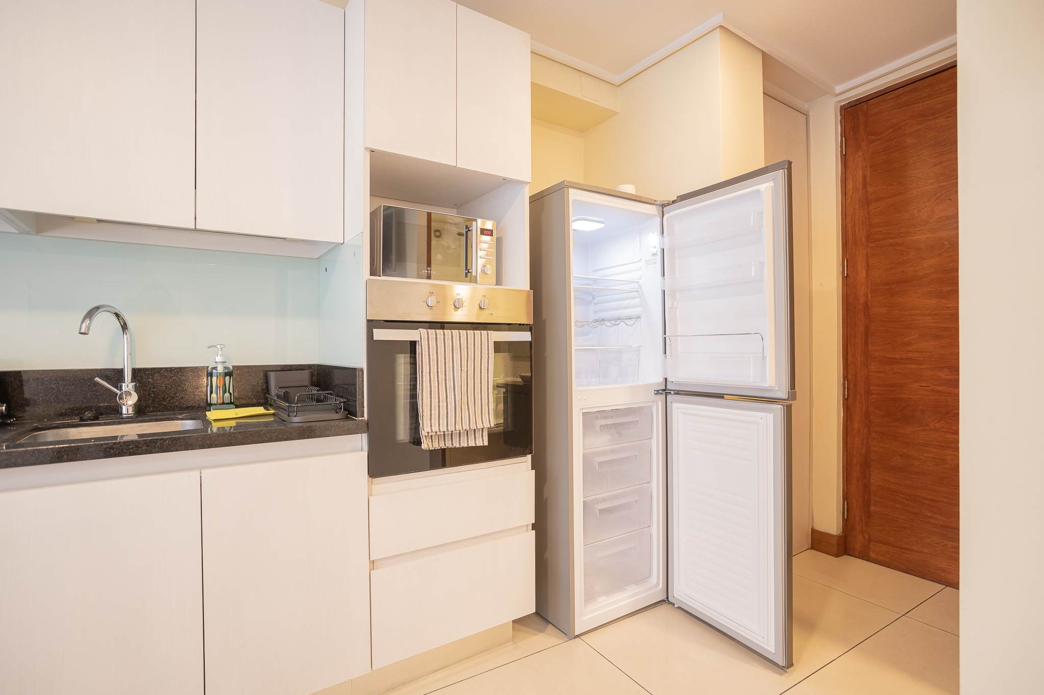 Modern kitchen with sleek appliances and ample storage, perfect for preparing meals during your stay.
