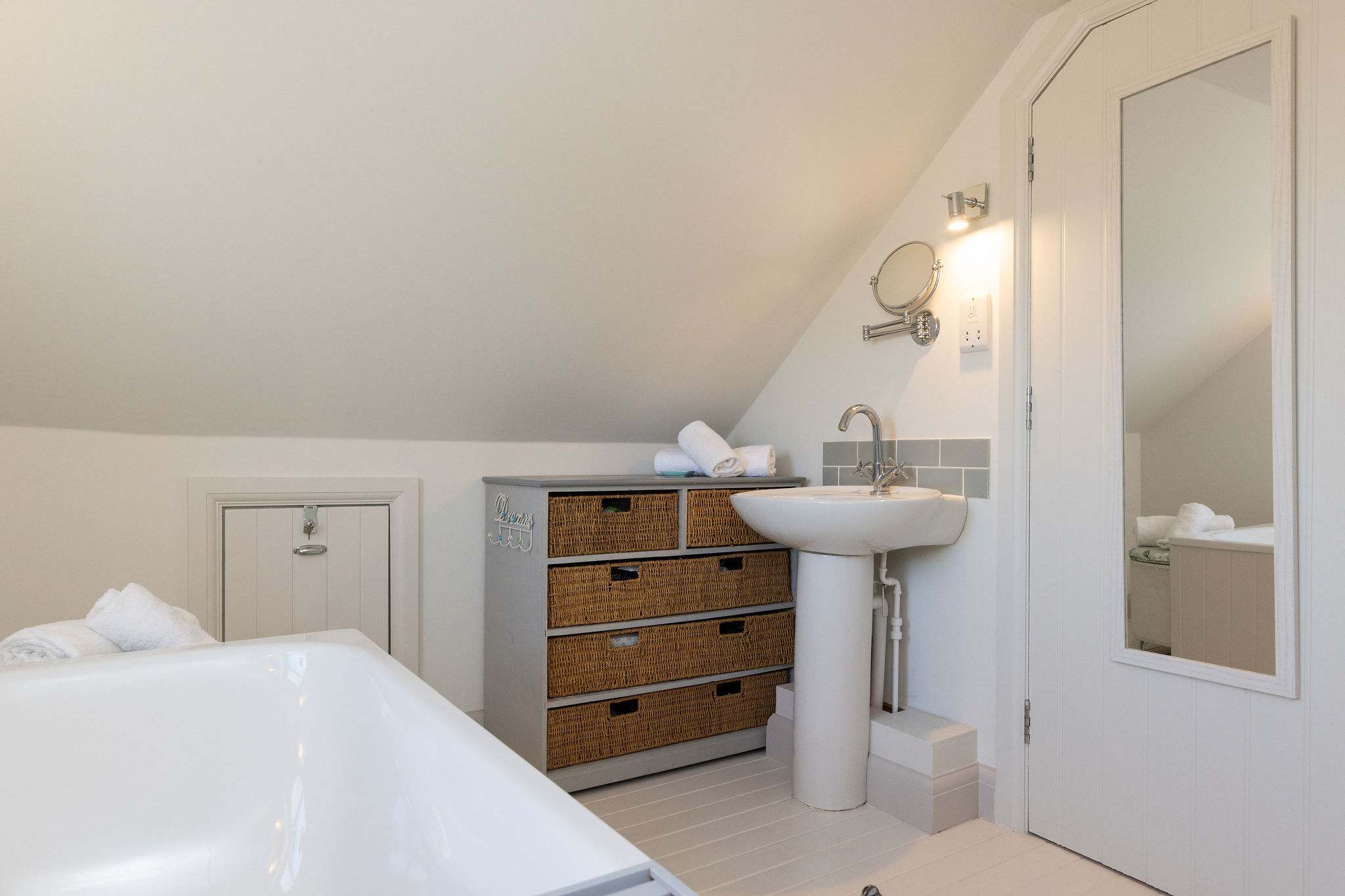 Bright and airy bathroom with thoughtful storage and soft coastal styling