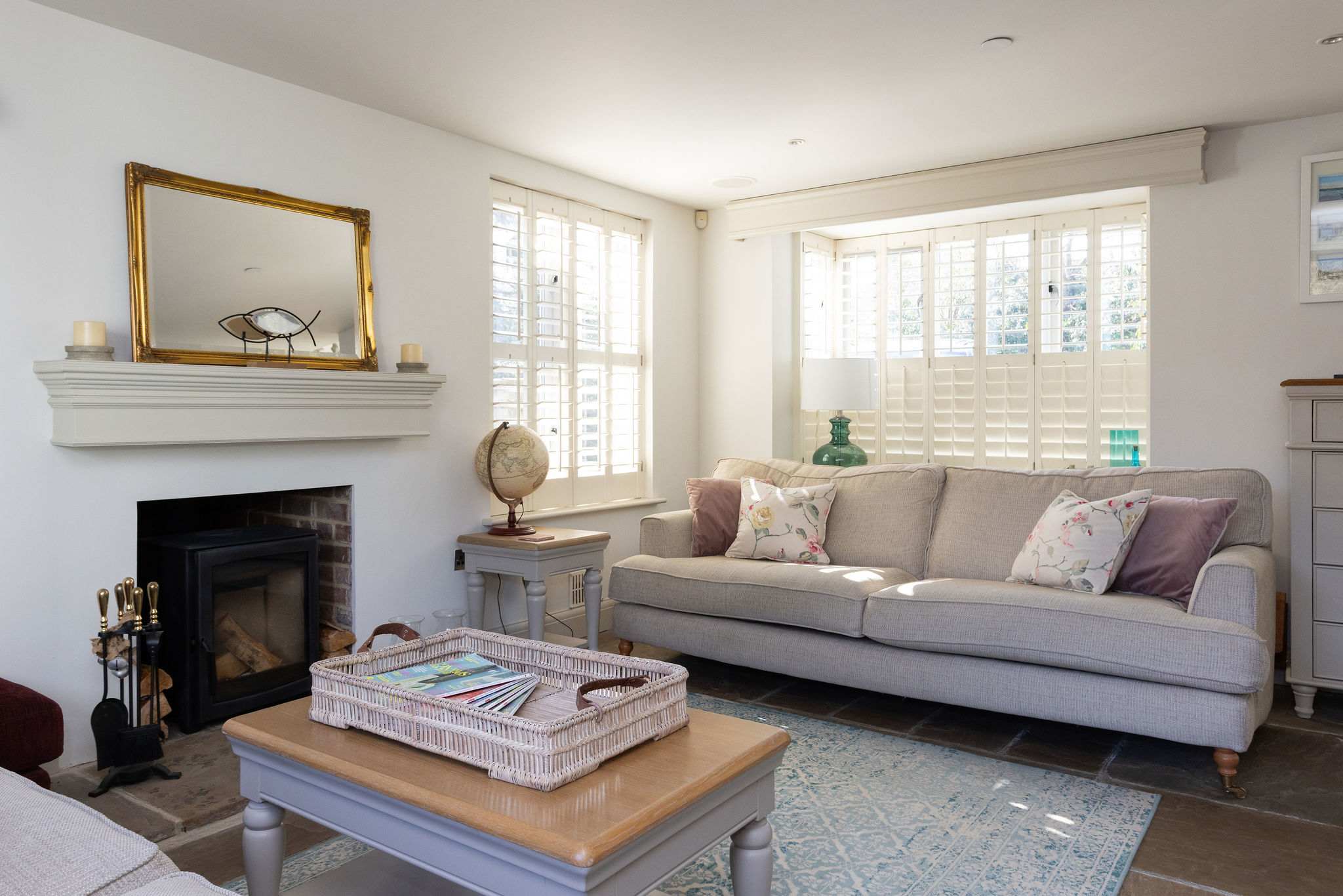 Light-filled lounge with comfortable seating and soft coastal touches
