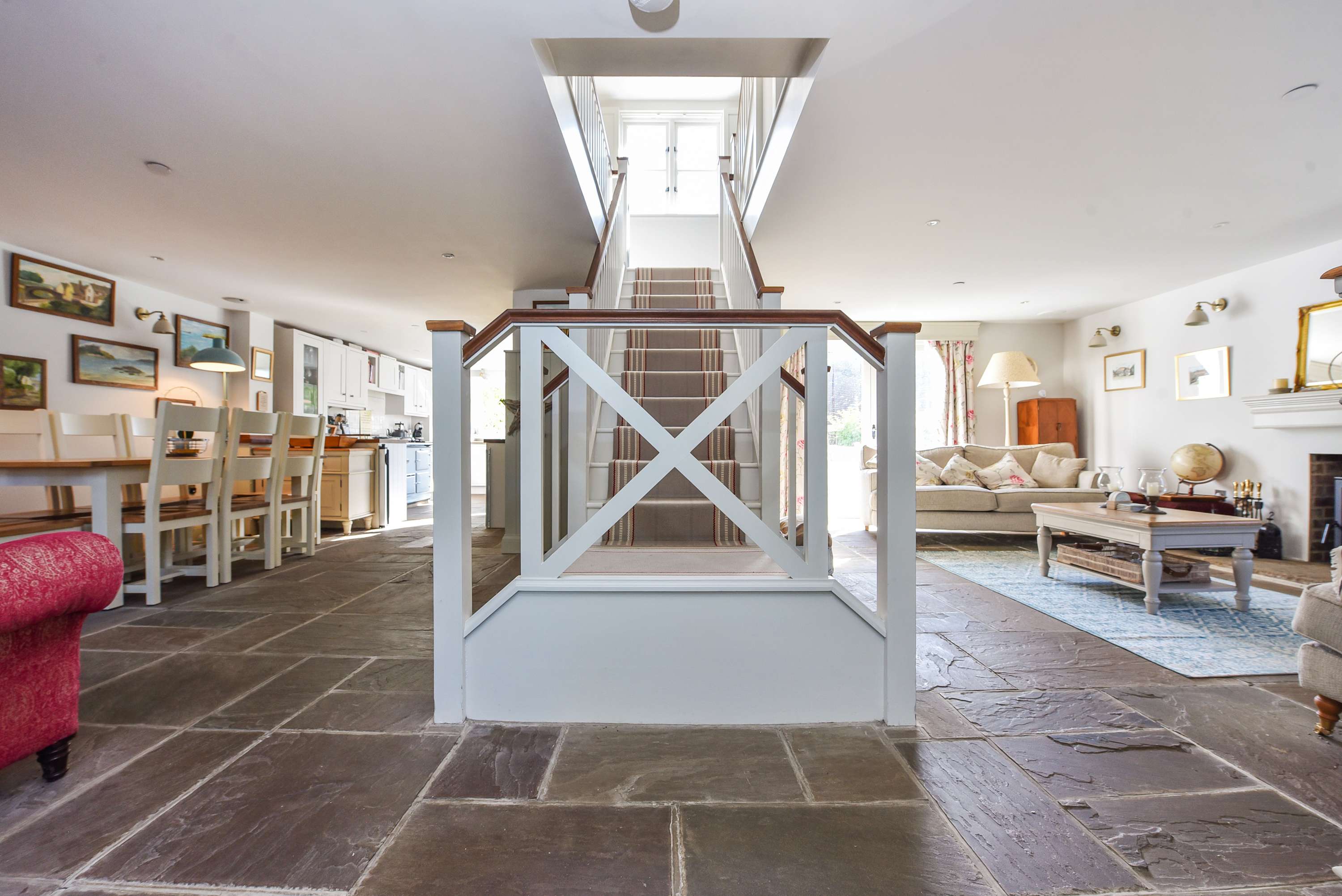 Spacious open-plan layout with central staircase, dining area and cosy lounge