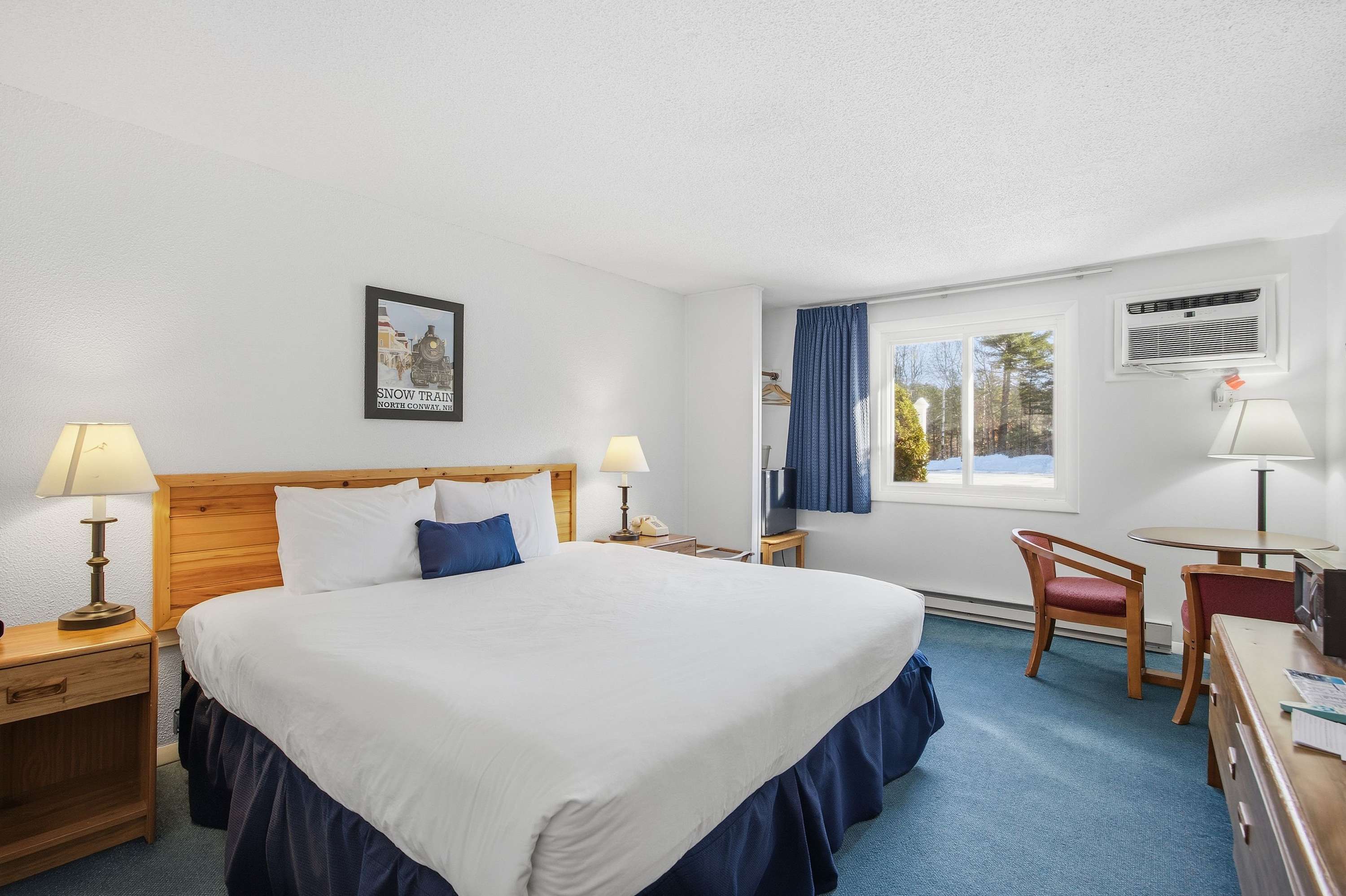 This charming suite boasts a plush king bed, dining area, & TV​