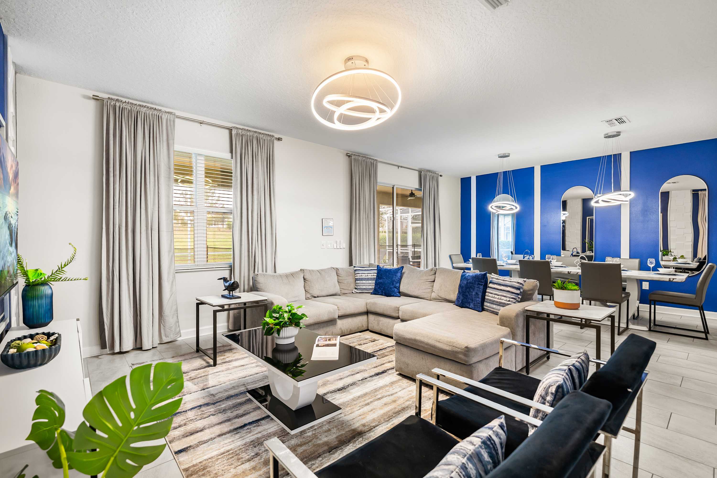 Spacious open-concept living area with modern design, dining space, and natural light.