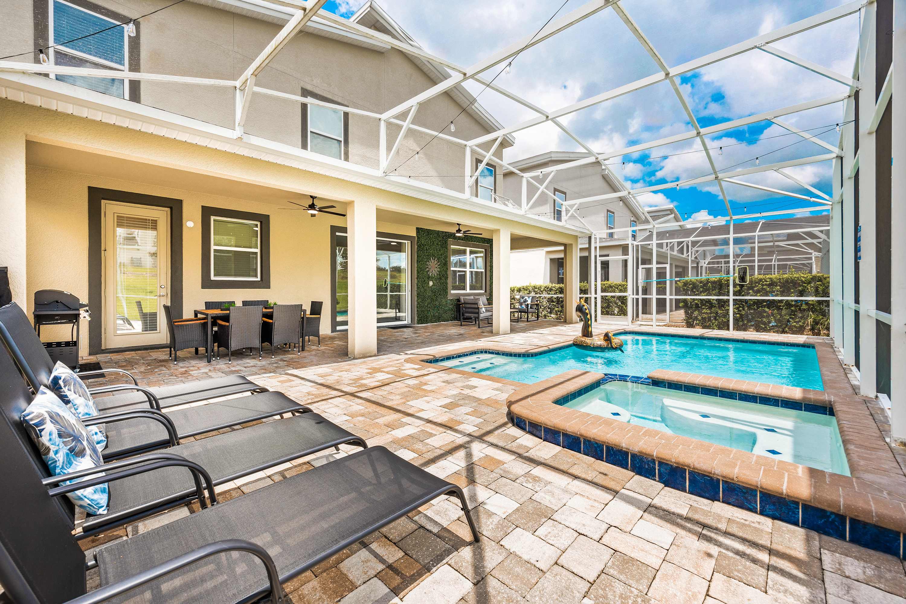 Private screened pool and spa with lounge area, perfect for relaxing under the Florida sun.